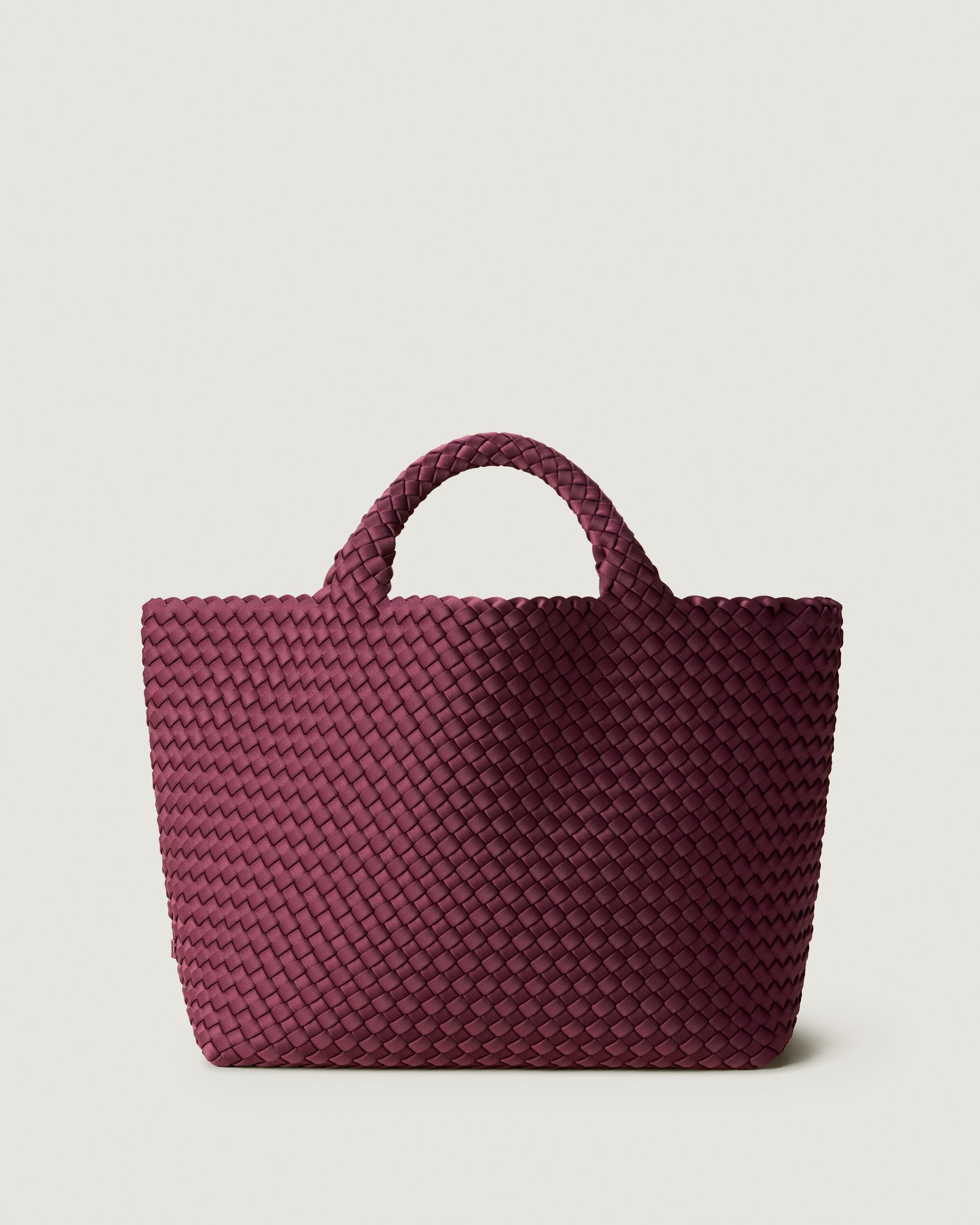 St. Barths Tote in Bordeaux, a rich burgundy tone, in handwoven neoprene, featuring an open top, and woven top handles.