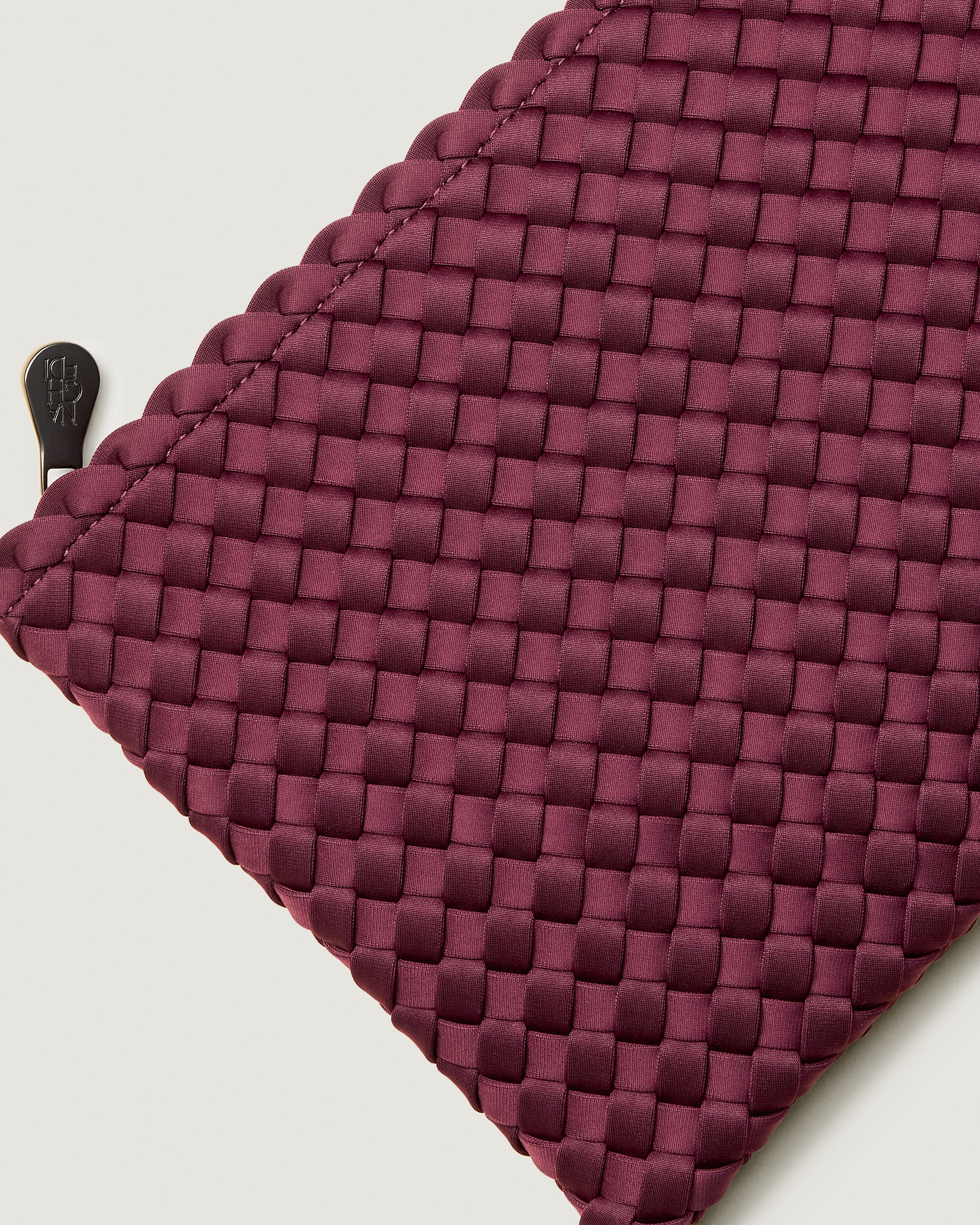Close-up of included matching woven zippered pouch.