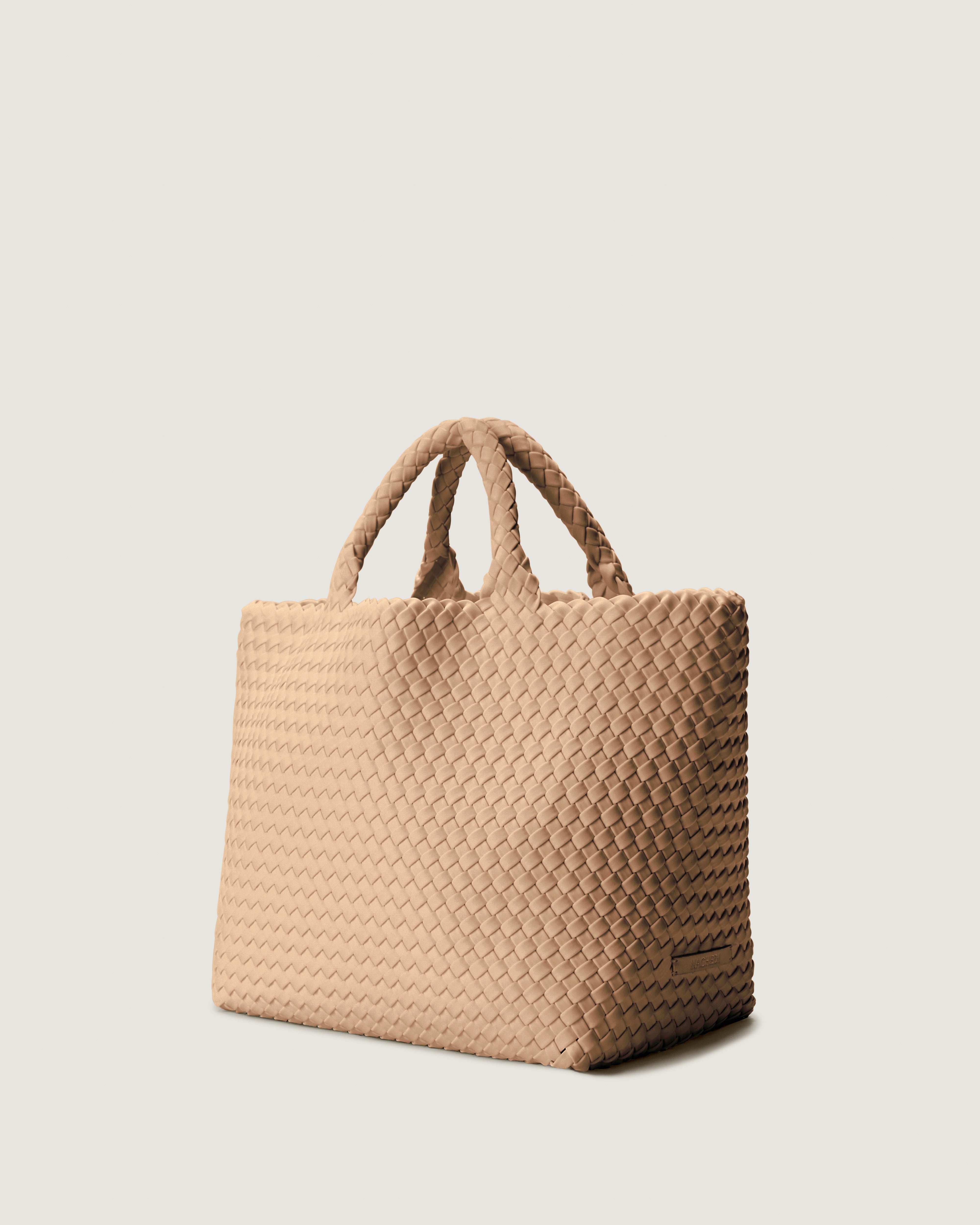 St Barths Tote in Camel shown from a side angle, highlighting its handwoven neoprene construction and open top with magnetic snap closure.