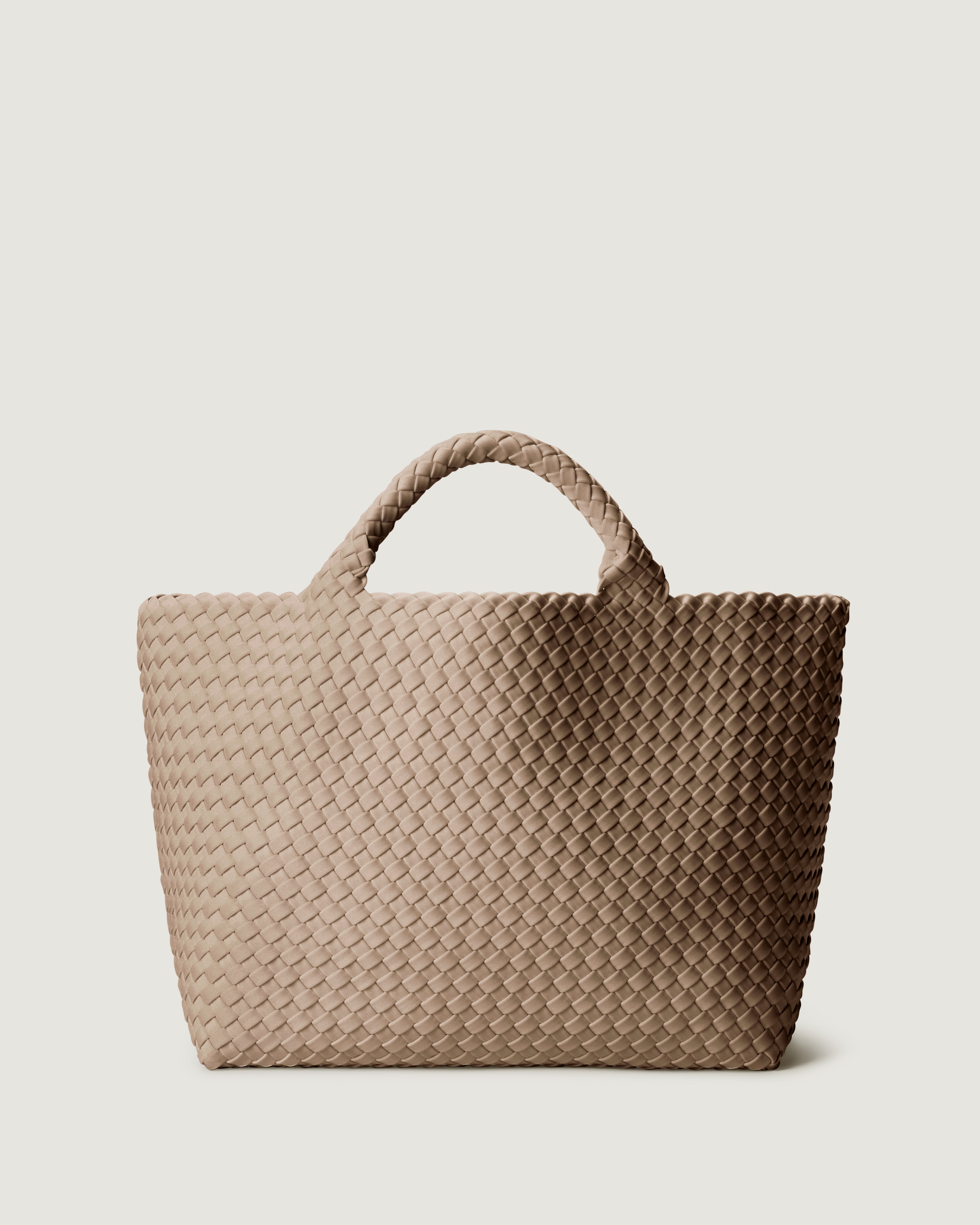 St. Barths Tote in Cashmere, a taupe tone, in handwoven neoprene, featuring an open top, and woven top handles.
