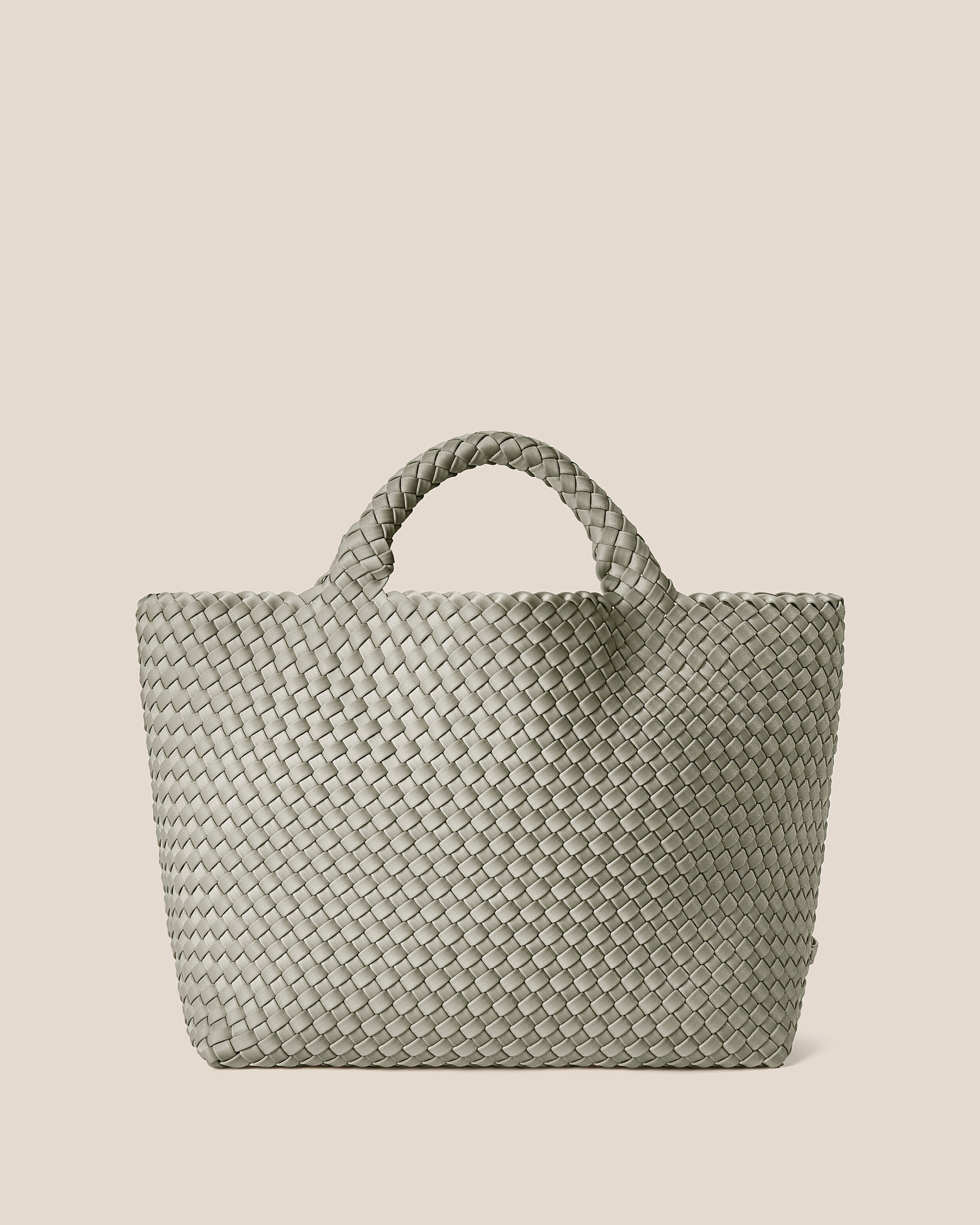 St. Barths Tote in Celadon, a light jade green tone, in handwoven neoprene, featuring an open top, and woven top handles.