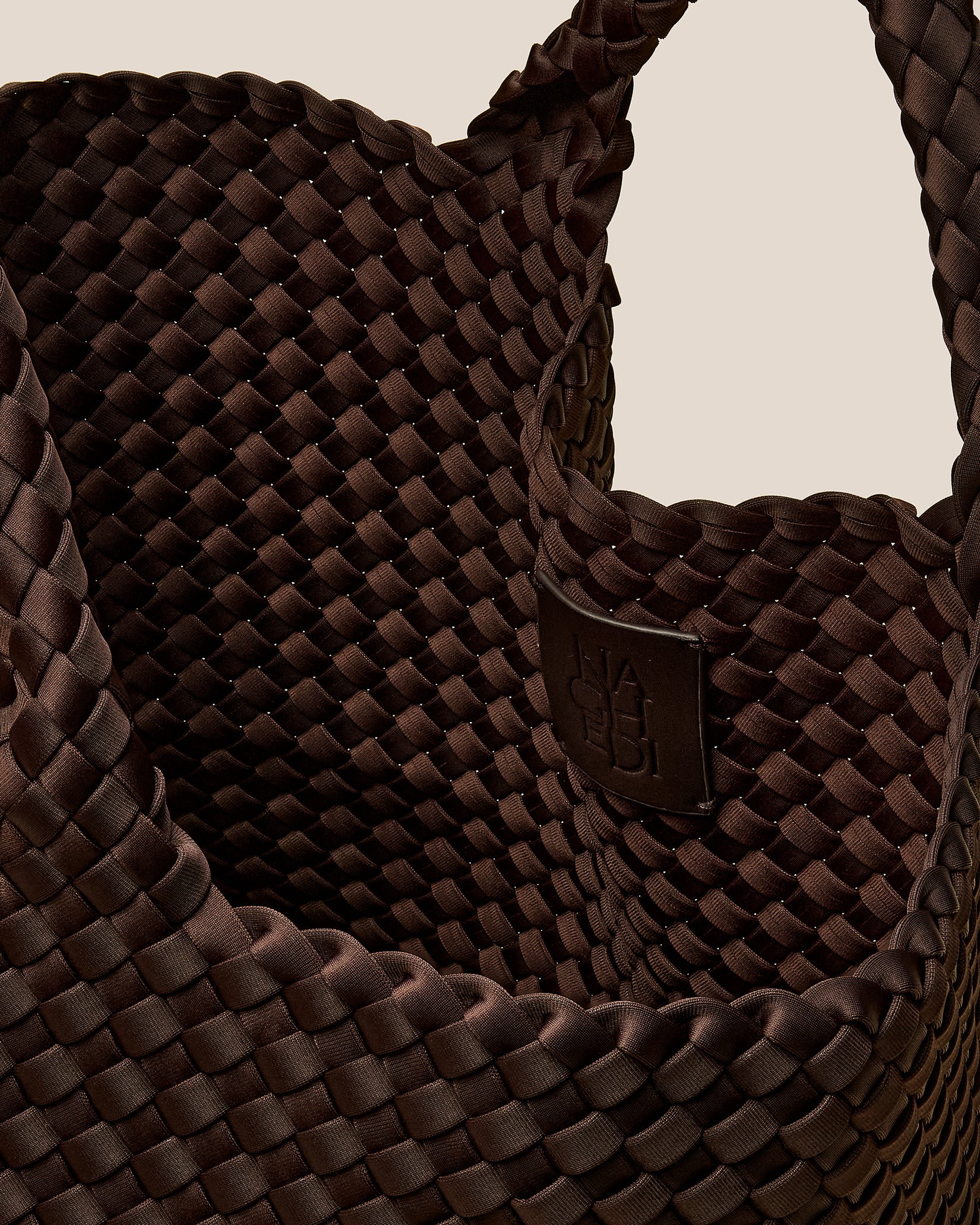 Interior close-up of St. Barths Medium Tote Bag in Chocolate showing its open top, and unlined interior.