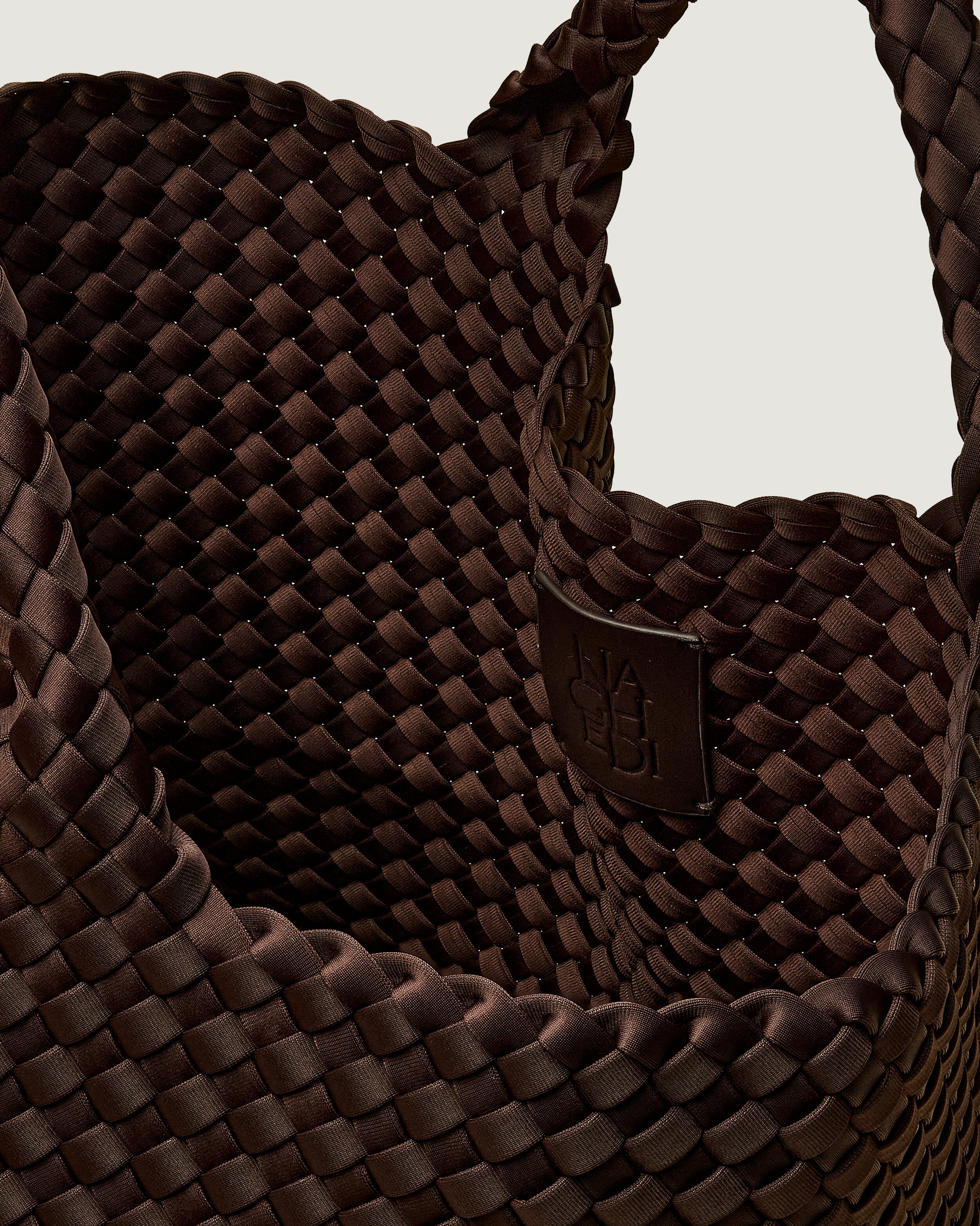 Interior close-up of St. Barths Tote in Chocolate showing its open top, and unlined interior.