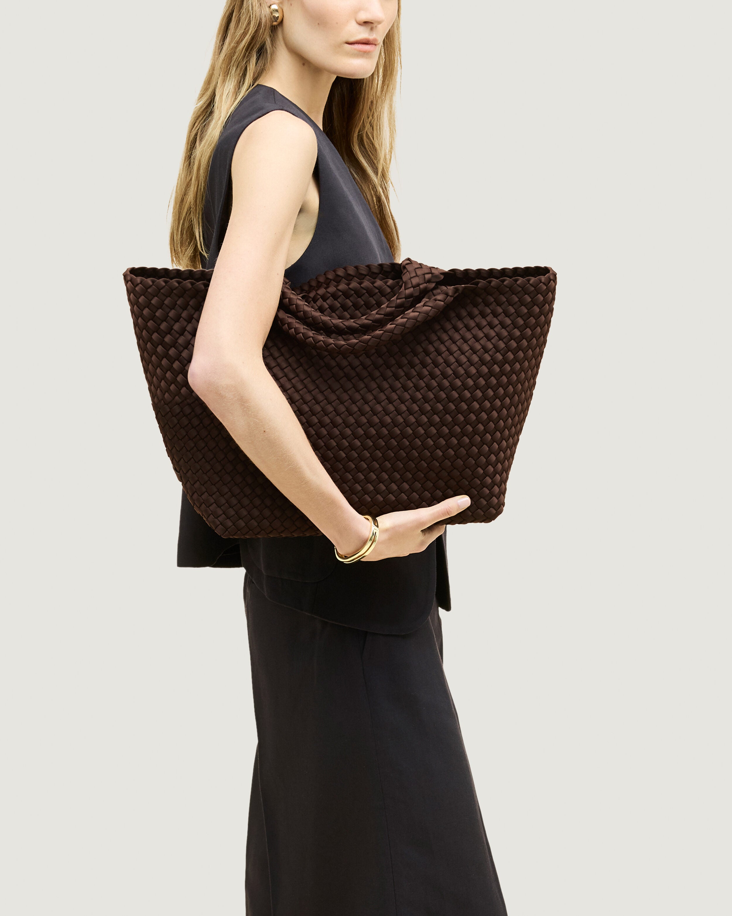 St. Barths Tote in Chocolate shown on model to illustrate scale and soft silhouette.