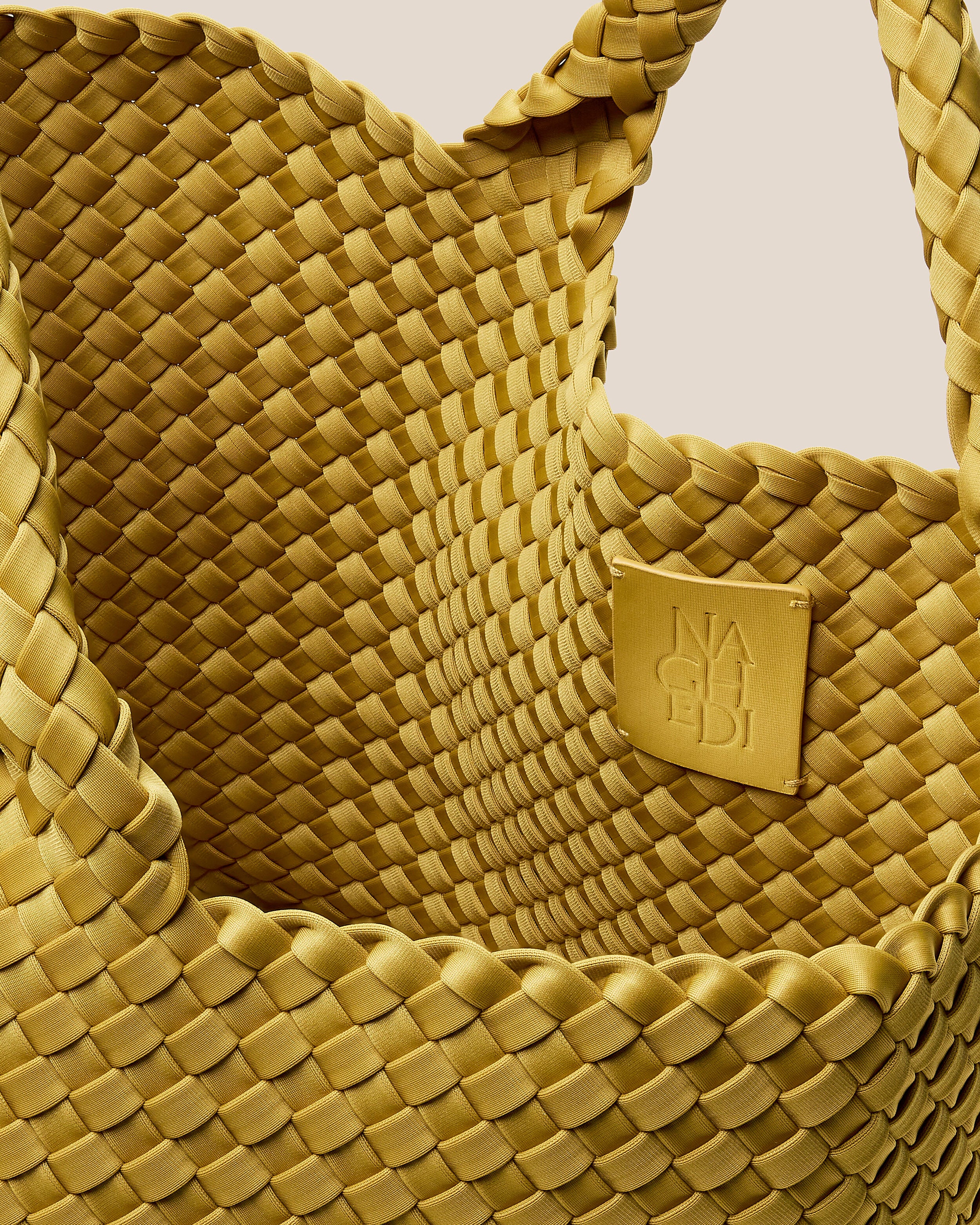 Interior close-up of St. Barths Tote in Citrine showing its open top, and unlined interior.