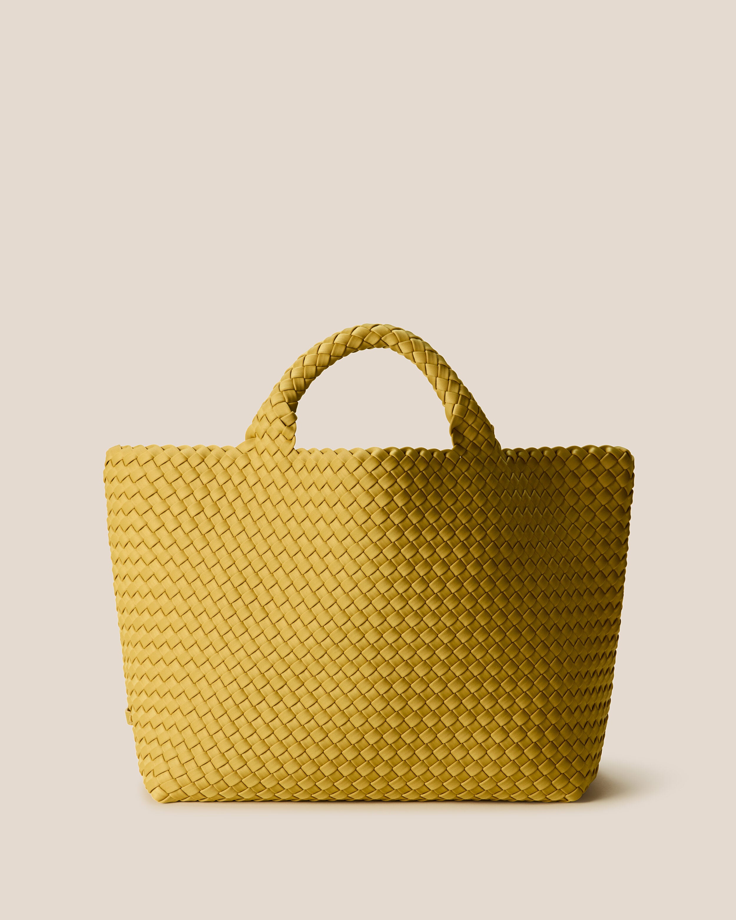 St. Barths Tote in Citrine, a mustard gold tone, in handwoven neoprene, featuring an open top, and woven top handles.