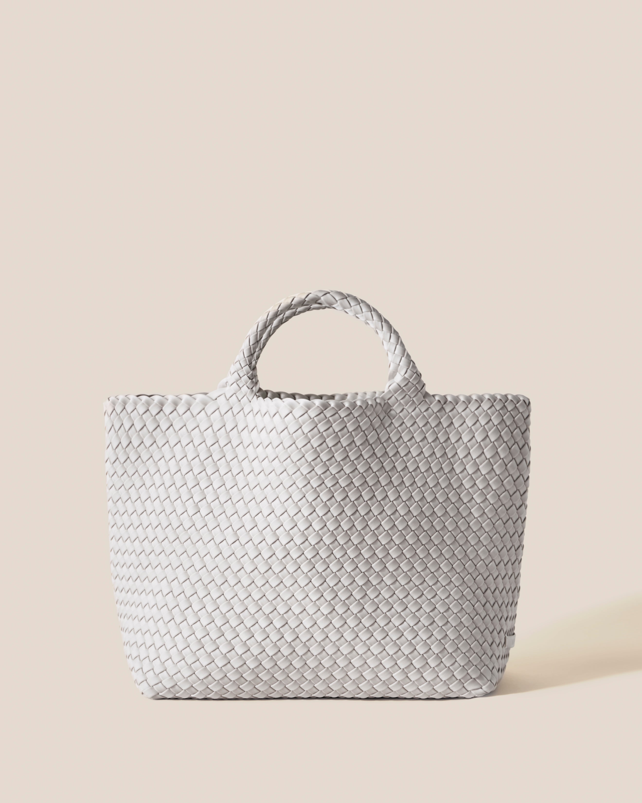 St. Barths Tote in Dove, a light grey tone, in handwoven neoprene, featuring an open top, and woven top handles.