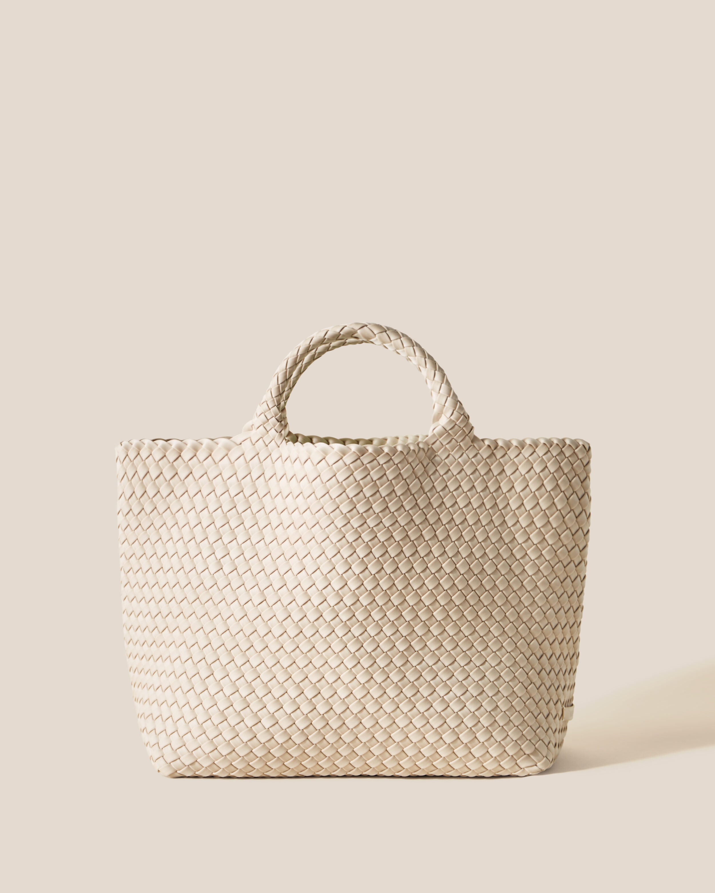 St. Barths Tote in Ecru, a cream tone, in handwoven neoprene, featuring an open top, and woven top handles.