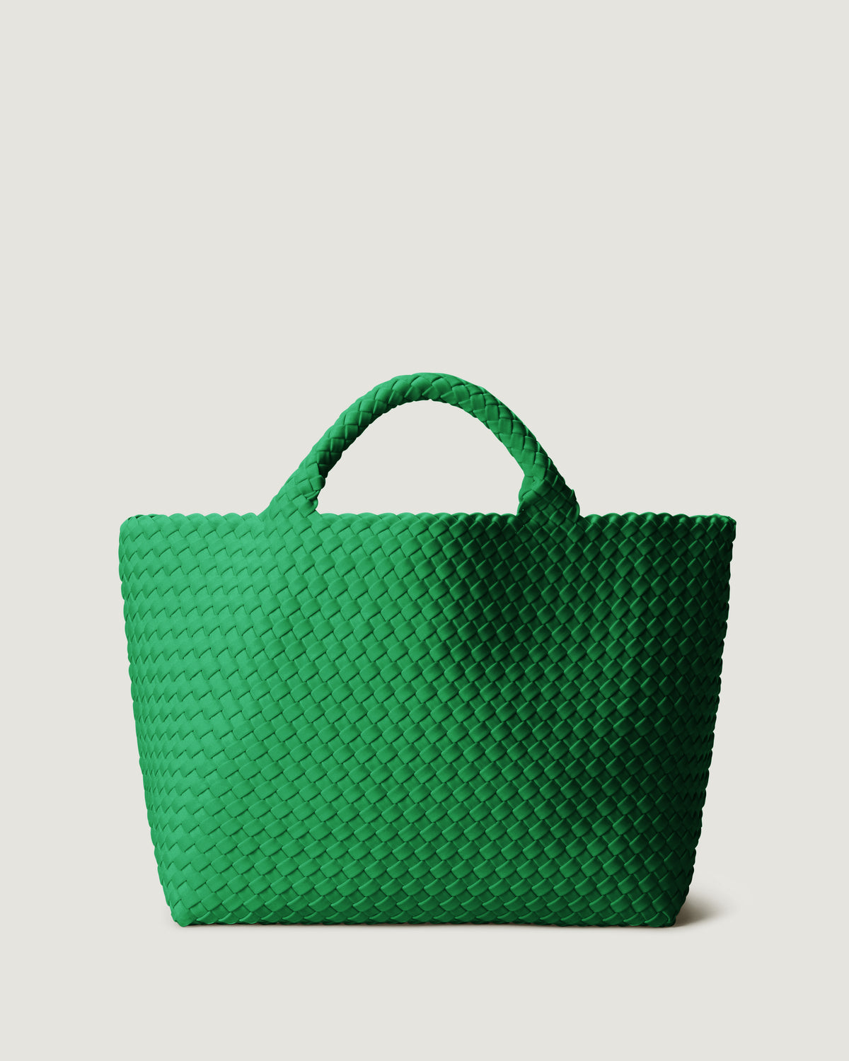 St. Barths Tote in Emerald in handwoven neoprene, featuring a magnetic closure, and woven top handles.