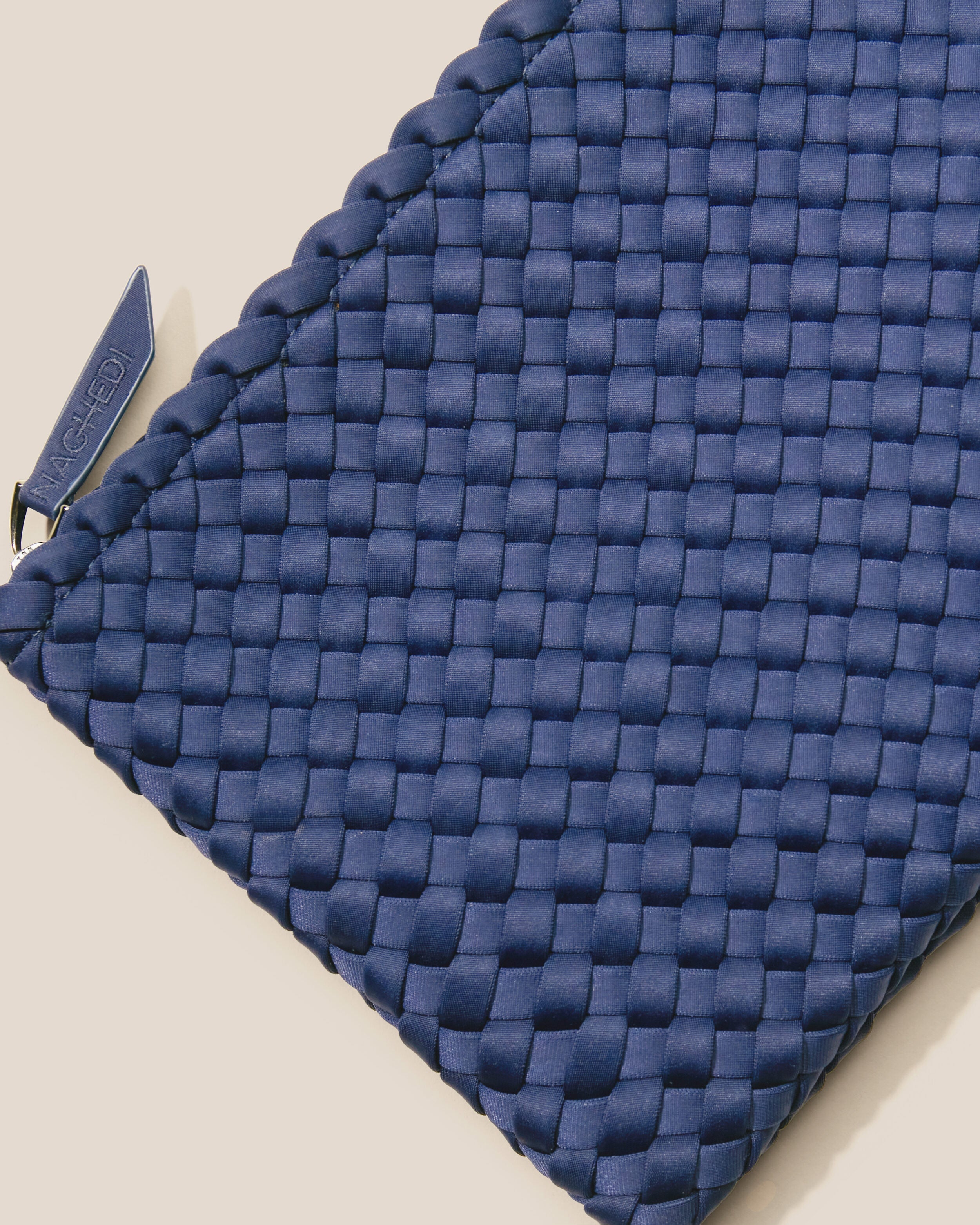 Close-up of included matching woven zippered pouch.