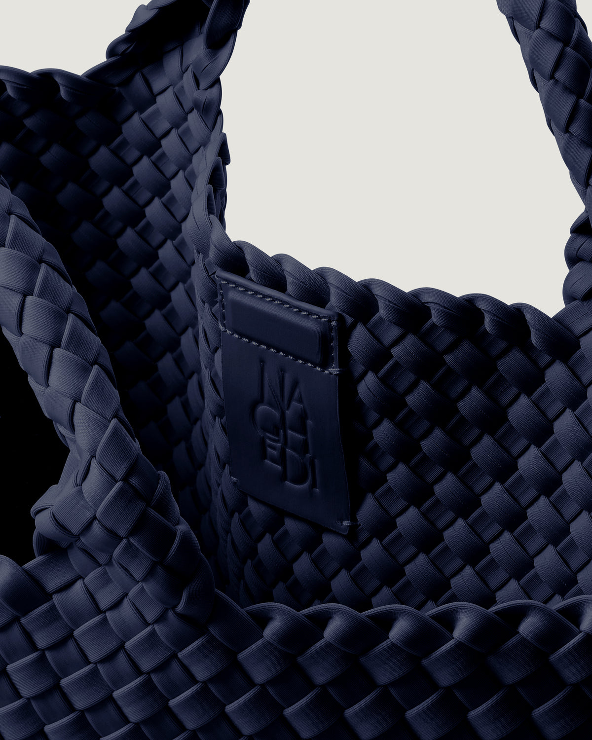 Interior close-up of St. Barths Tote in Ink Blue showing its magnetic snap closure, and unlined interior.