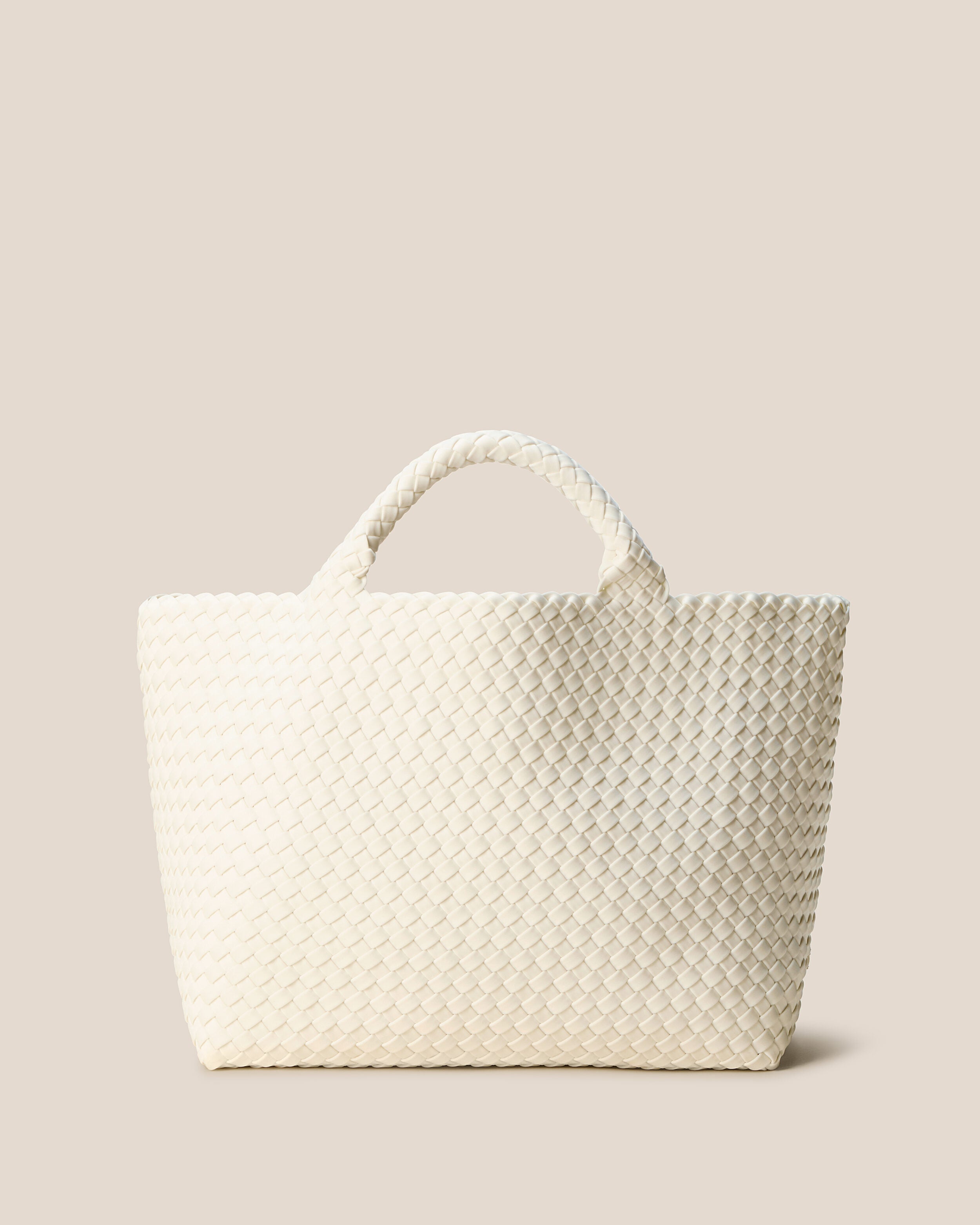 St. Barths Tote in Jasmine, an ivory tone, in handwoven neoprene, featuring an open top, and woven top handles.