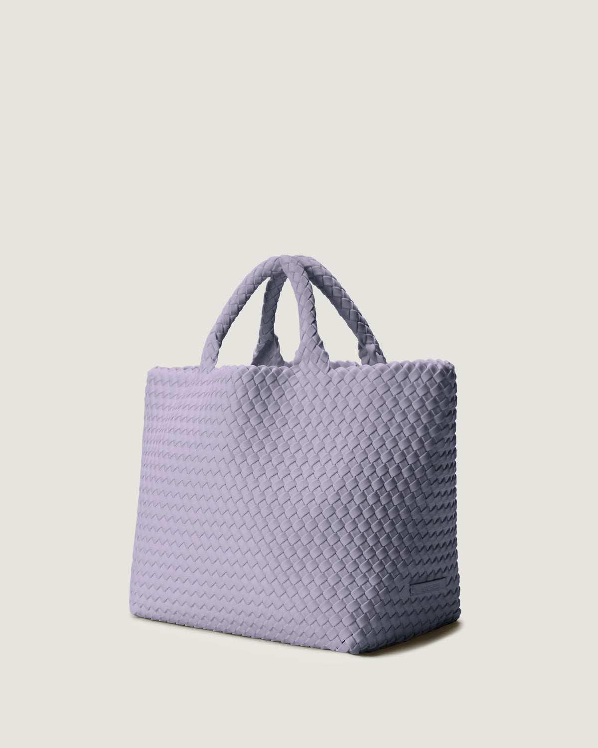 St Barths Tote in Lilac shown from a side angle, highlighting its handwoven neoprene construction and open top with magnetic snap closure.
