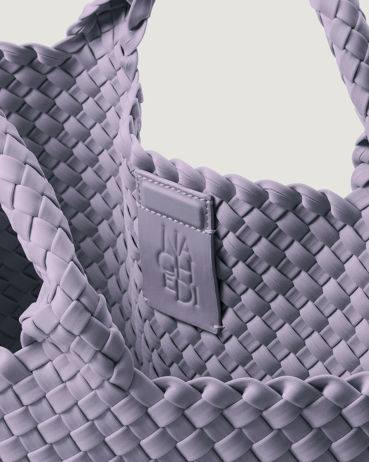 Interior close-up of St. Barths Tote in Lilac showing its magnetic snap closure, and unlined interior.