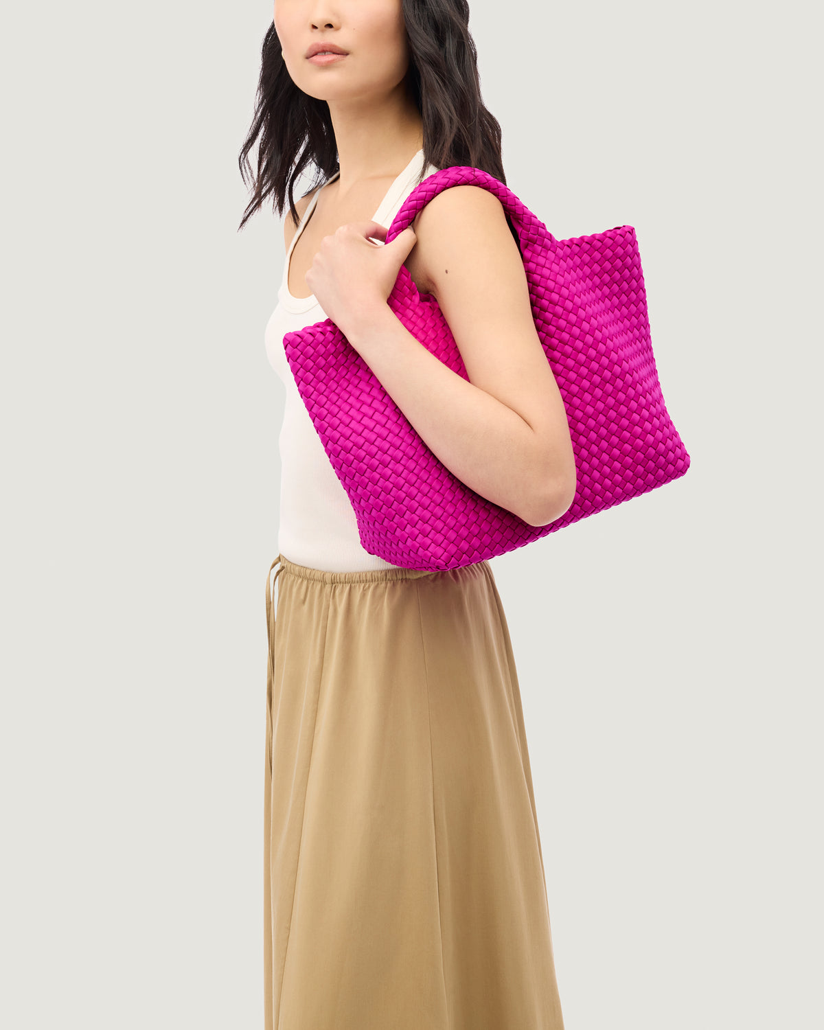St. Barths Tote in Miami Pink shown on model to illustrate scale and soft silhouette.