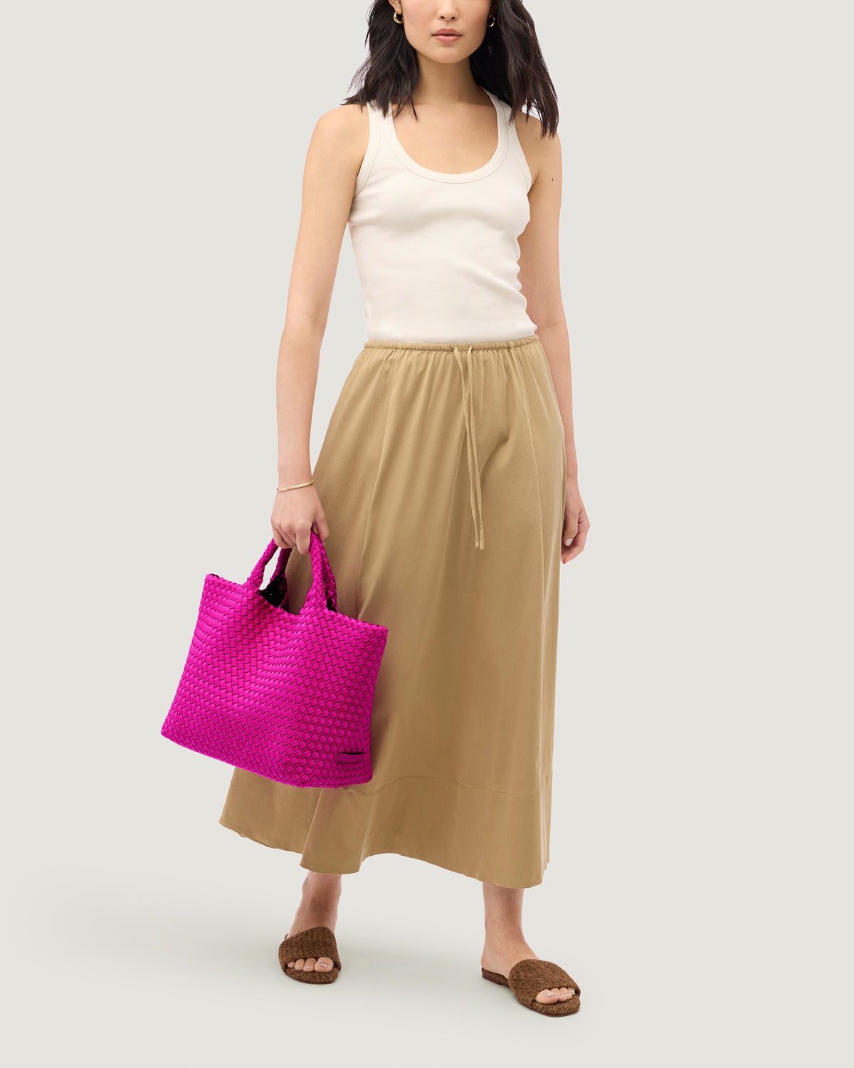 St. Barths Tote in Miami Pink shown on model to illustrate scale and soft silhouette.