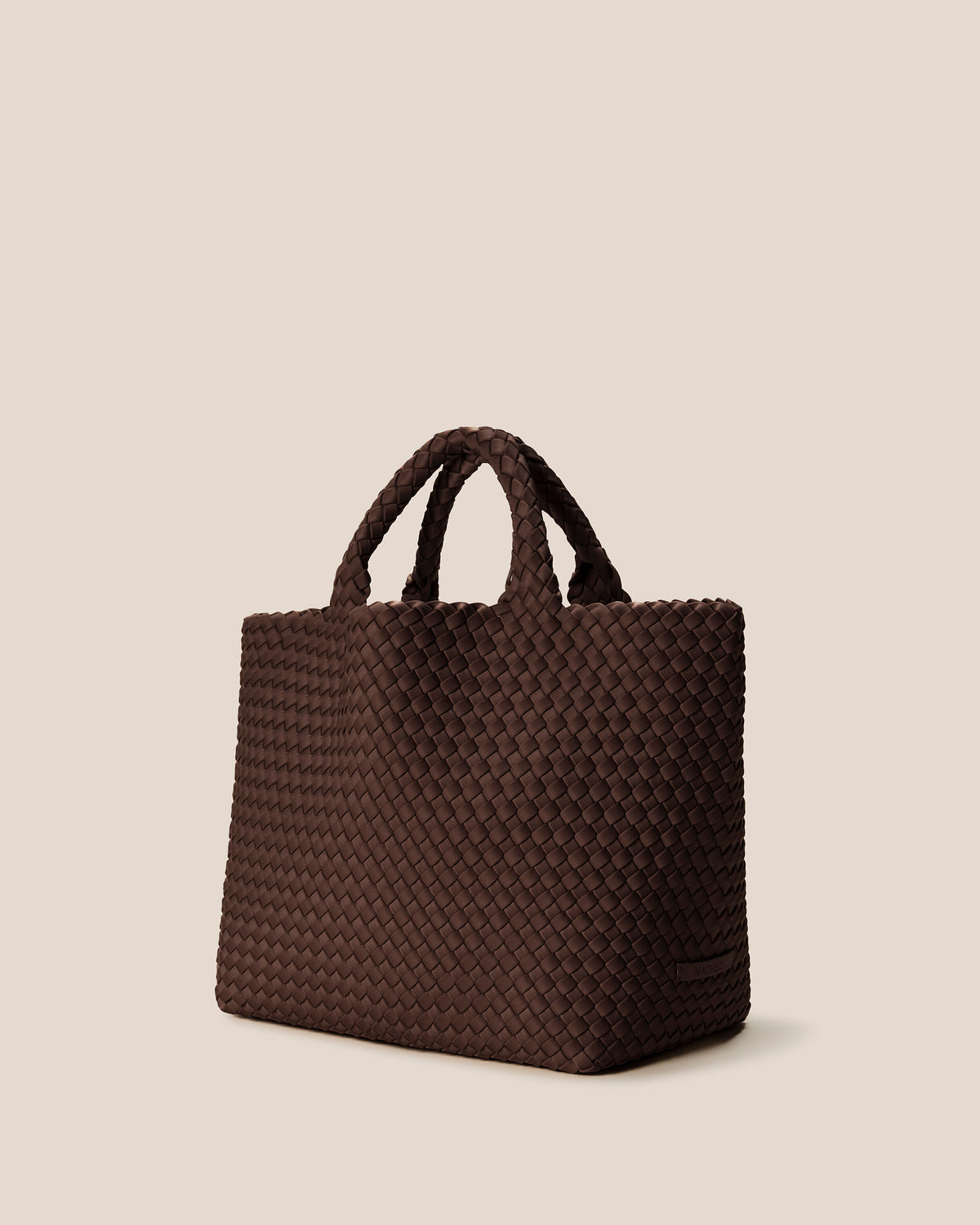 St. Barths Tote in Mocha shown from a side angle, highlighting its handwoven neoprene construction and open top.
