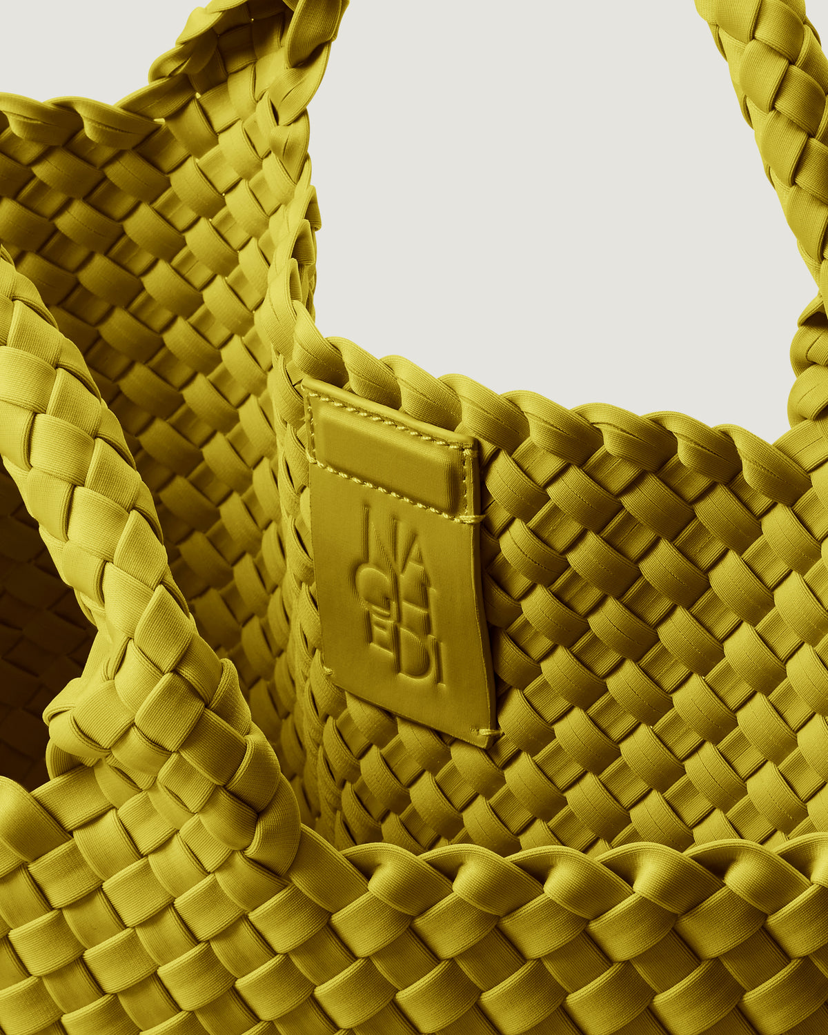 Interior close-up of St. Barths Tote in Ochre showing its magnetic snap closure, and unlined interior.