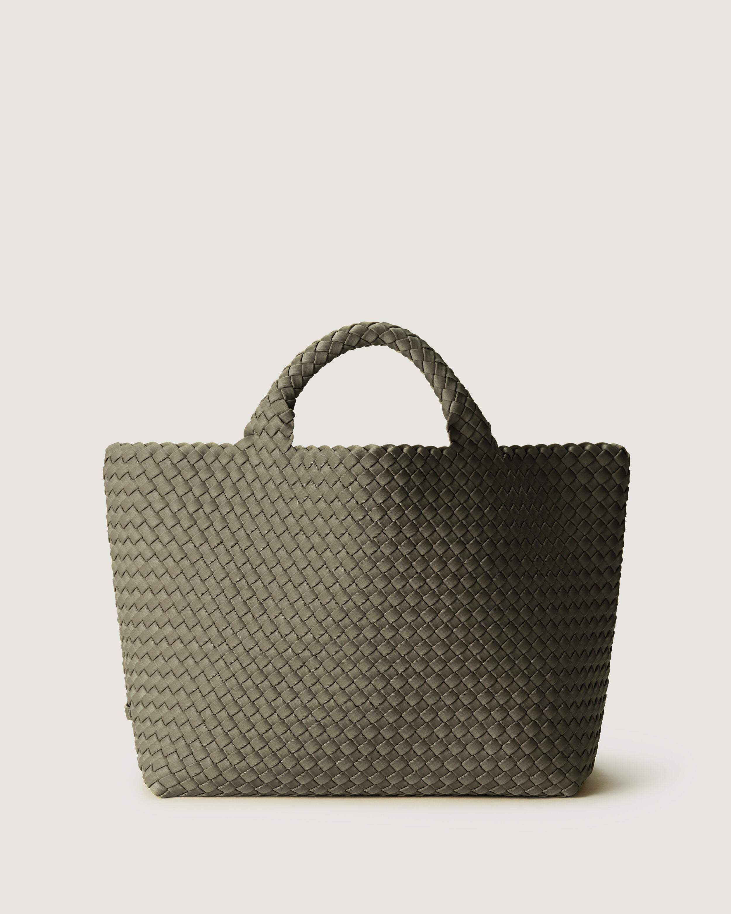 St. Barths Tote in Olea, a sage green tone, in handwoven neoprene, featuring an open top, and woven top handles.