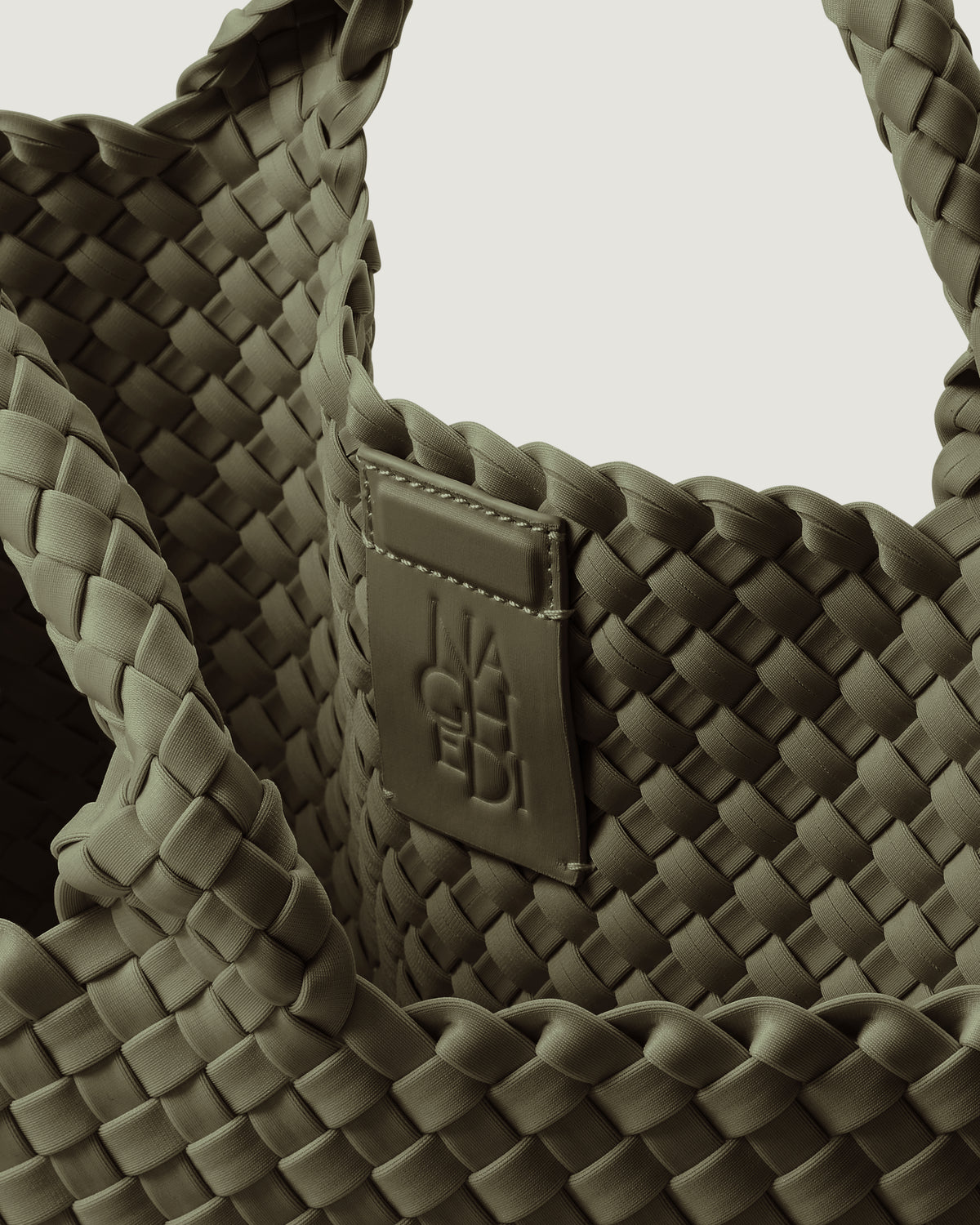 Interior close-up of St. Barths Tote in Olive showing its magnetic snap closure, and unlined interior.