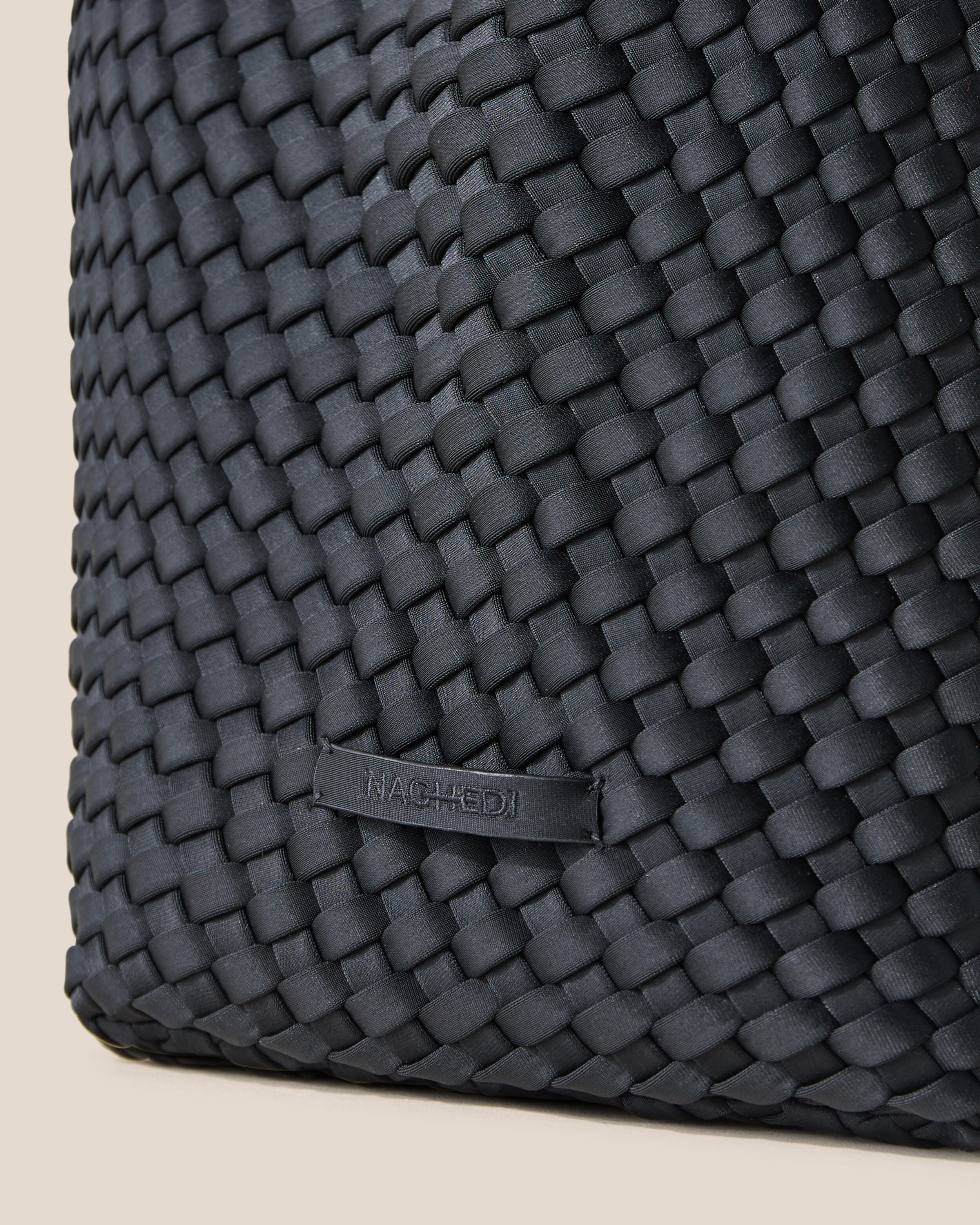 Close-up of stamped NAGHEDI logo on St. Barths Tote in Onyx.