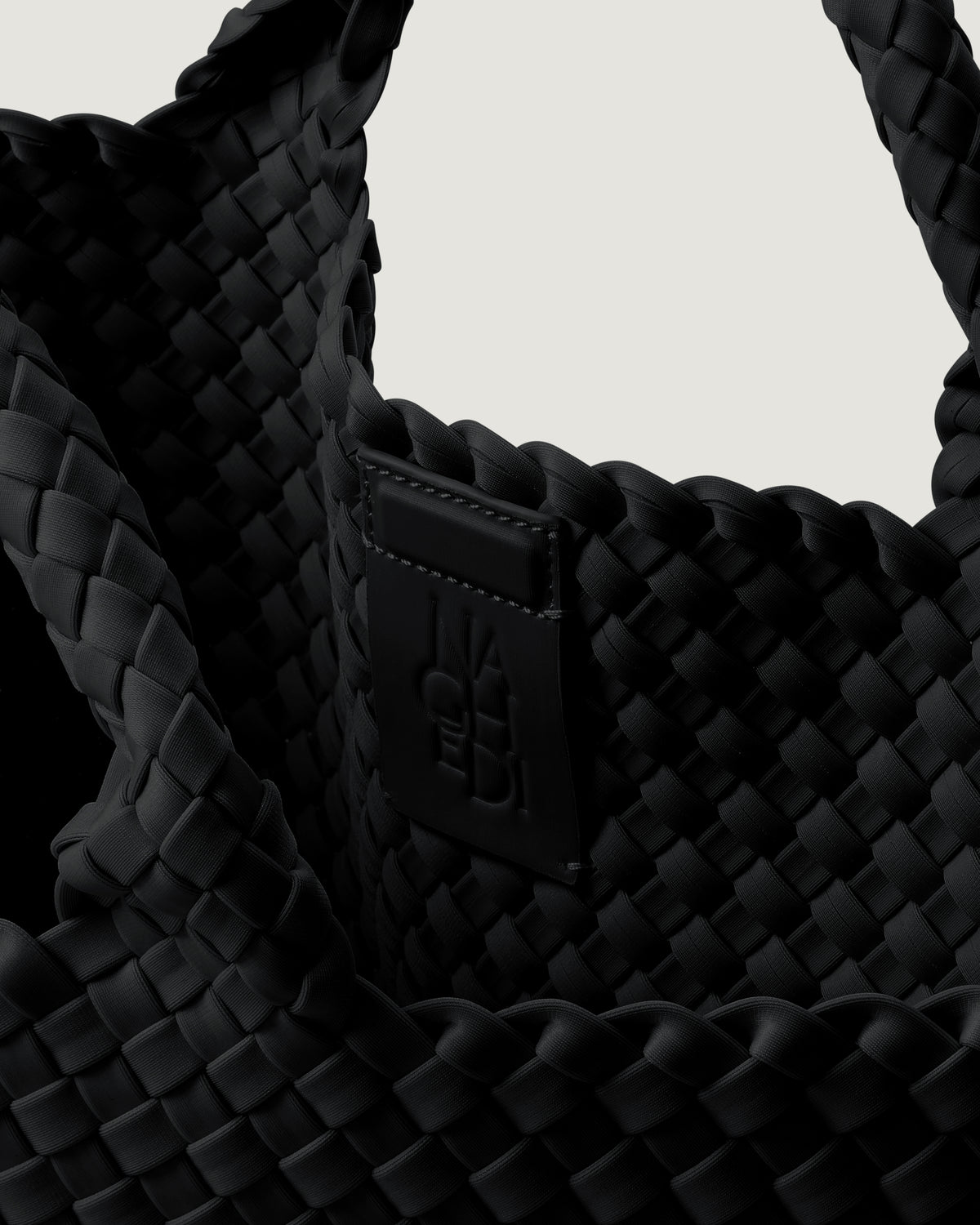 Interior close-up of St. Barths Tote in Onyx showing its magnetic snap closure, and unlined interior.