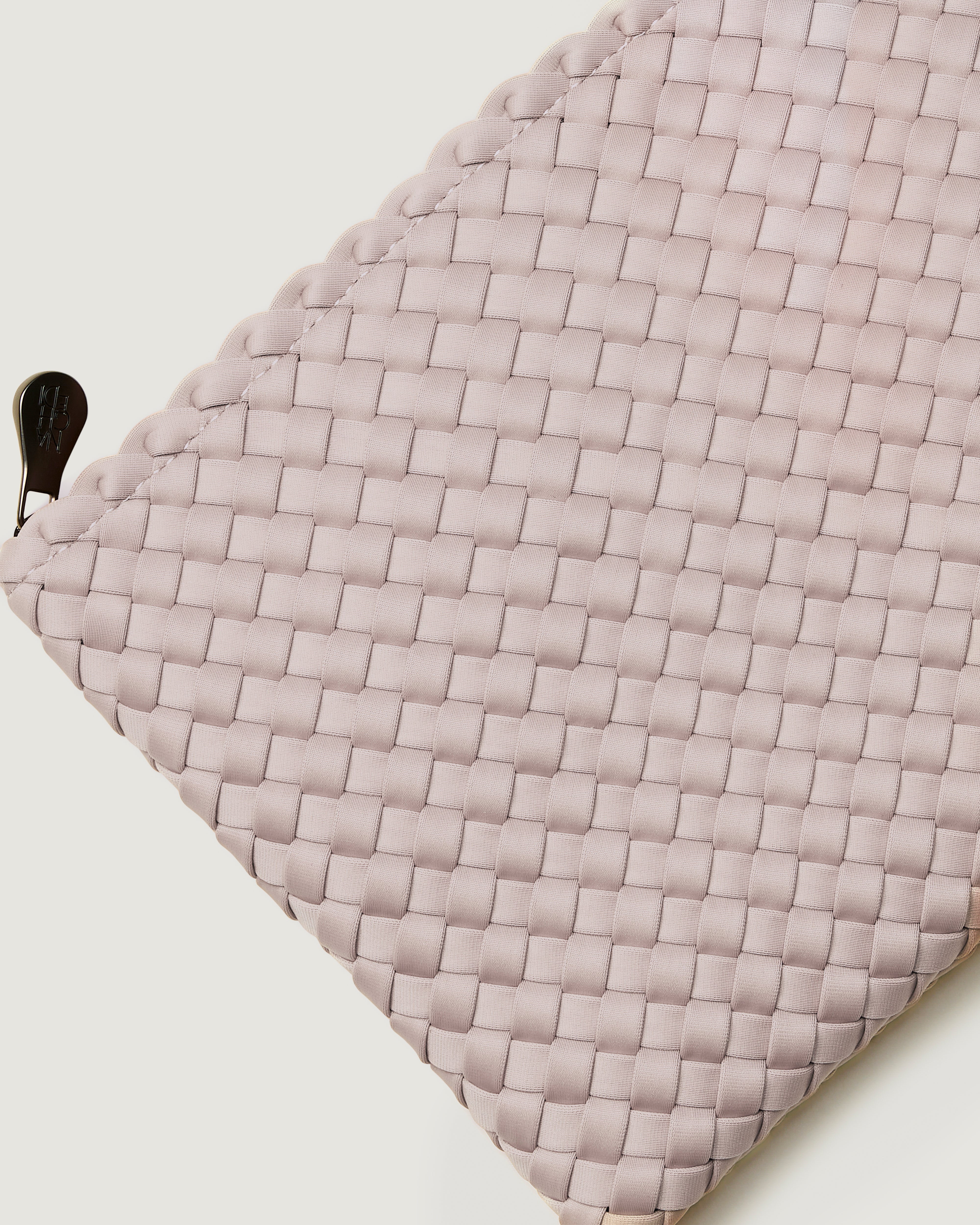 Close-up of included matching woven zippered pouch.