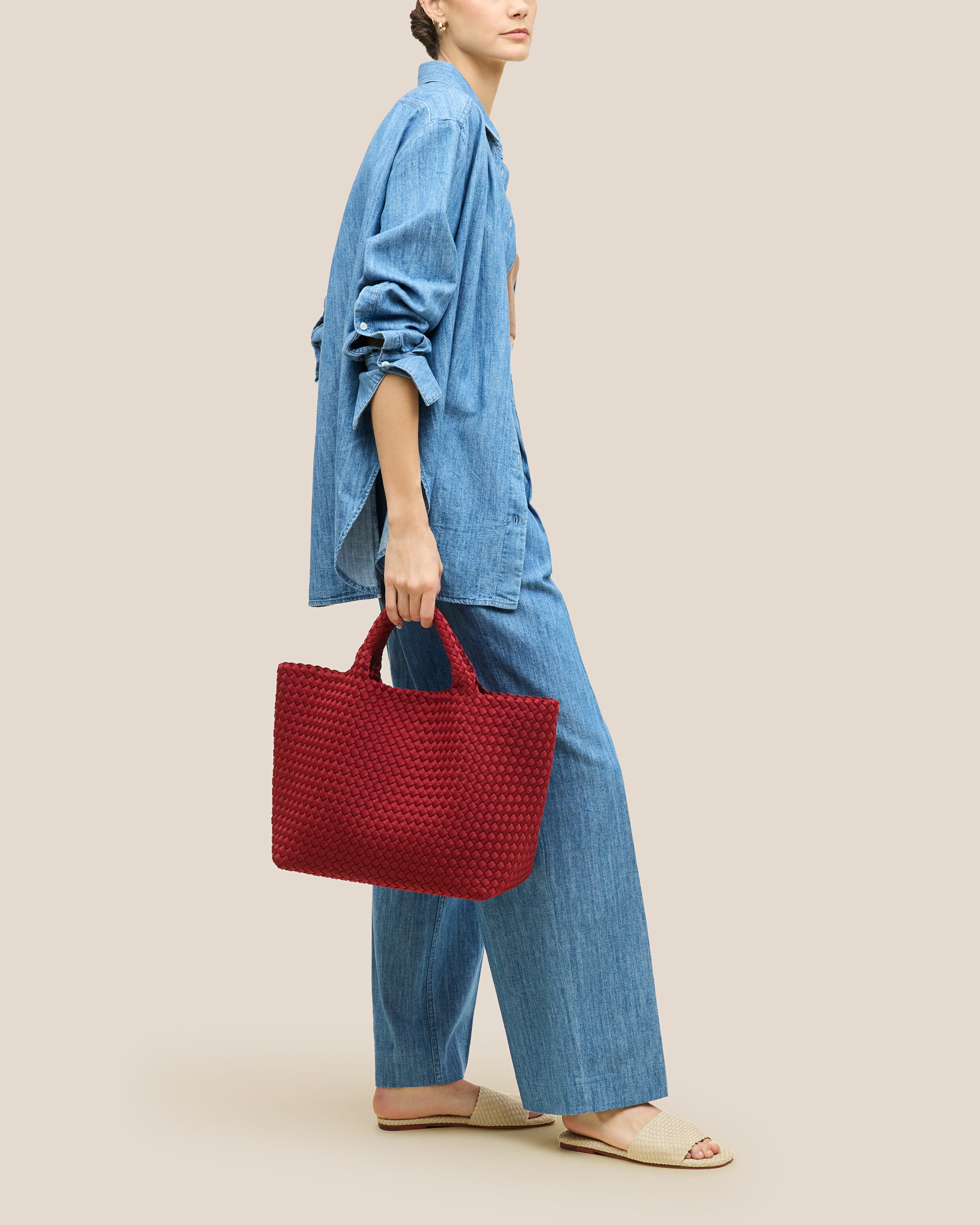 St. Barths Tote in Rosso shown on model to illustrate scale and soft silhouette.