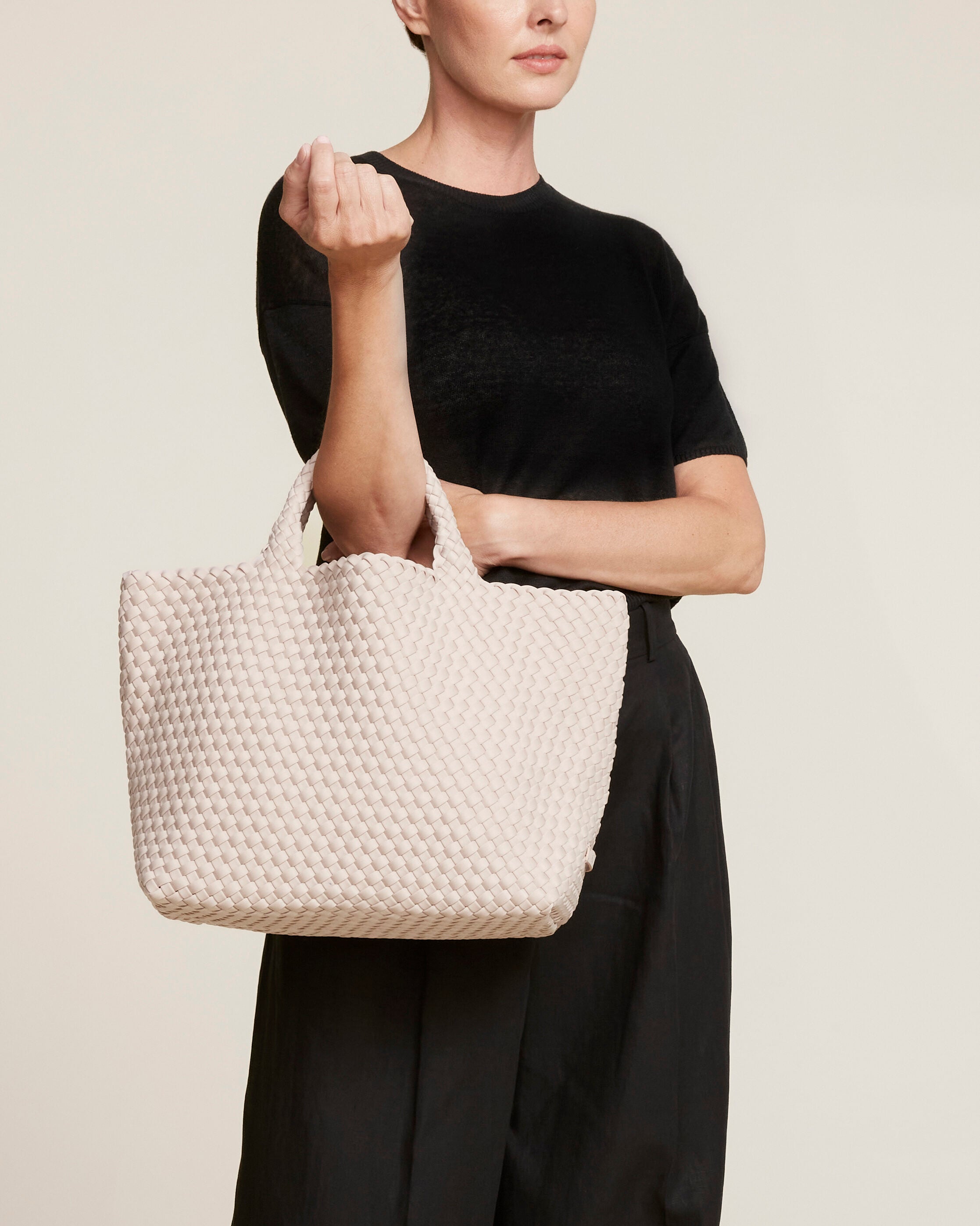 St. Barths Tote in Shell Pink shown on model to illustrate scale and soft silhouette.