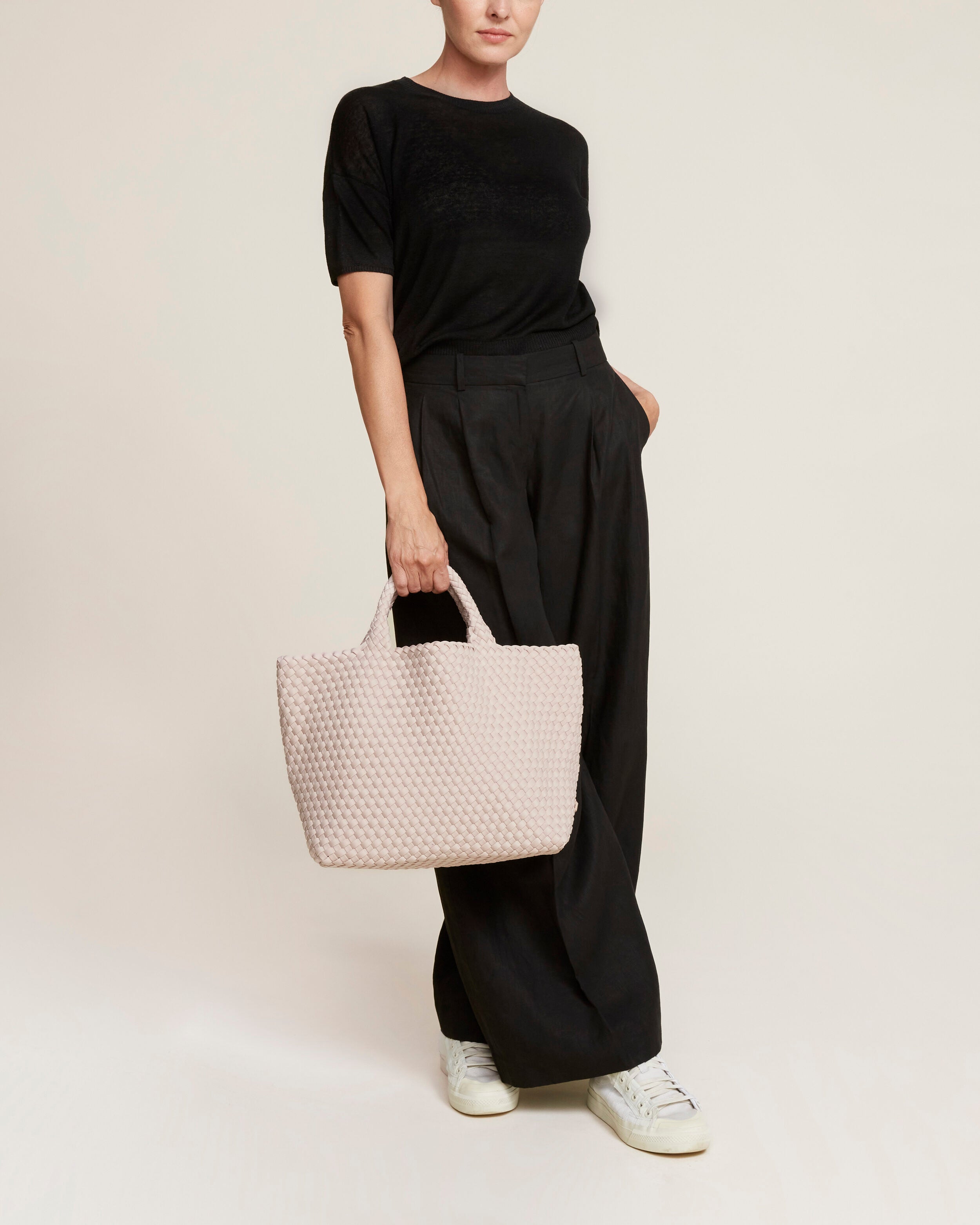 St. Barths Tote in Shell Pink shown on model to illustrate scale and soft silhouette.