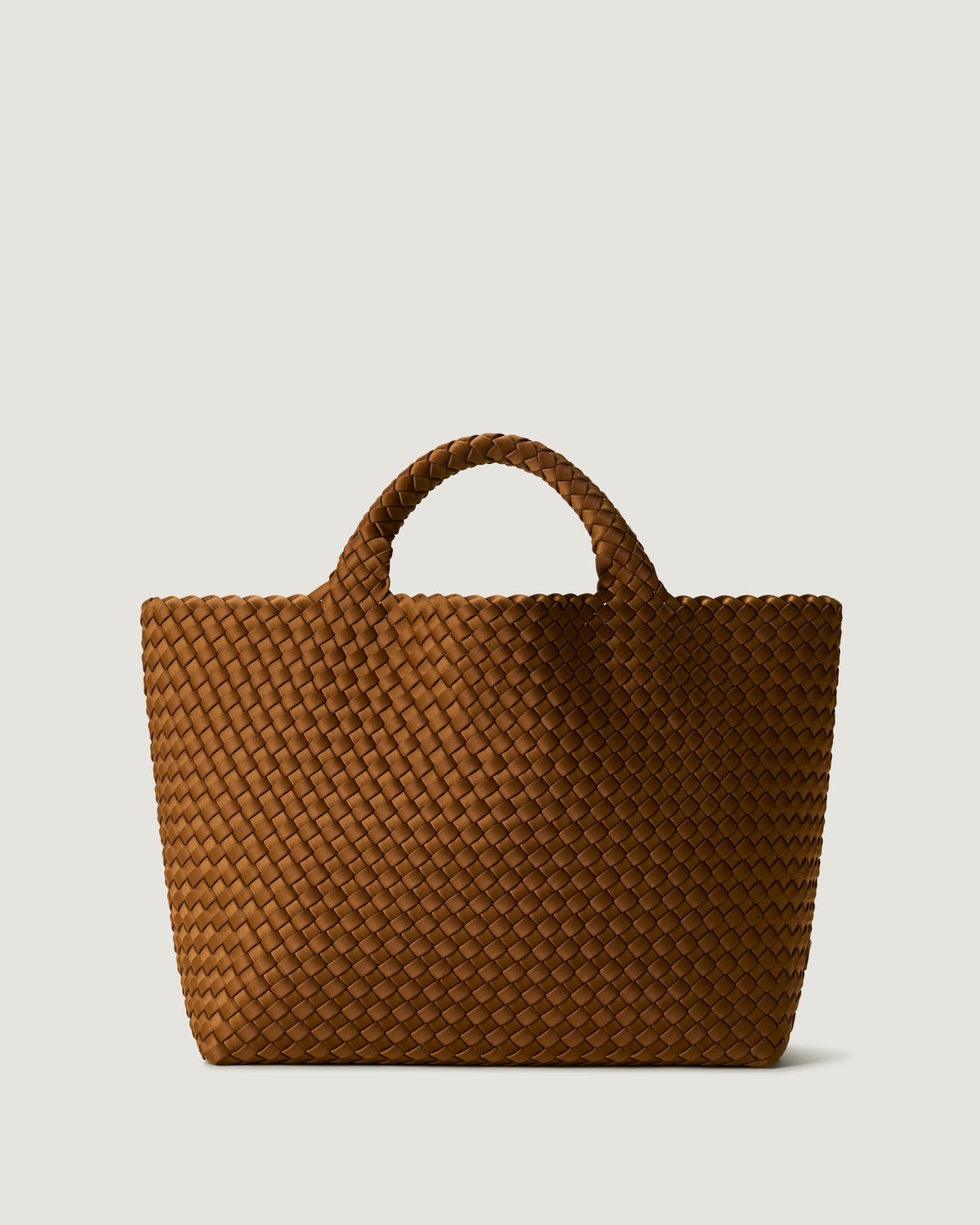 St. Barths Tote in Teak, a saddle brown tone, in handwoven neoprene, featuring a magnetic closure, and woven top handles.