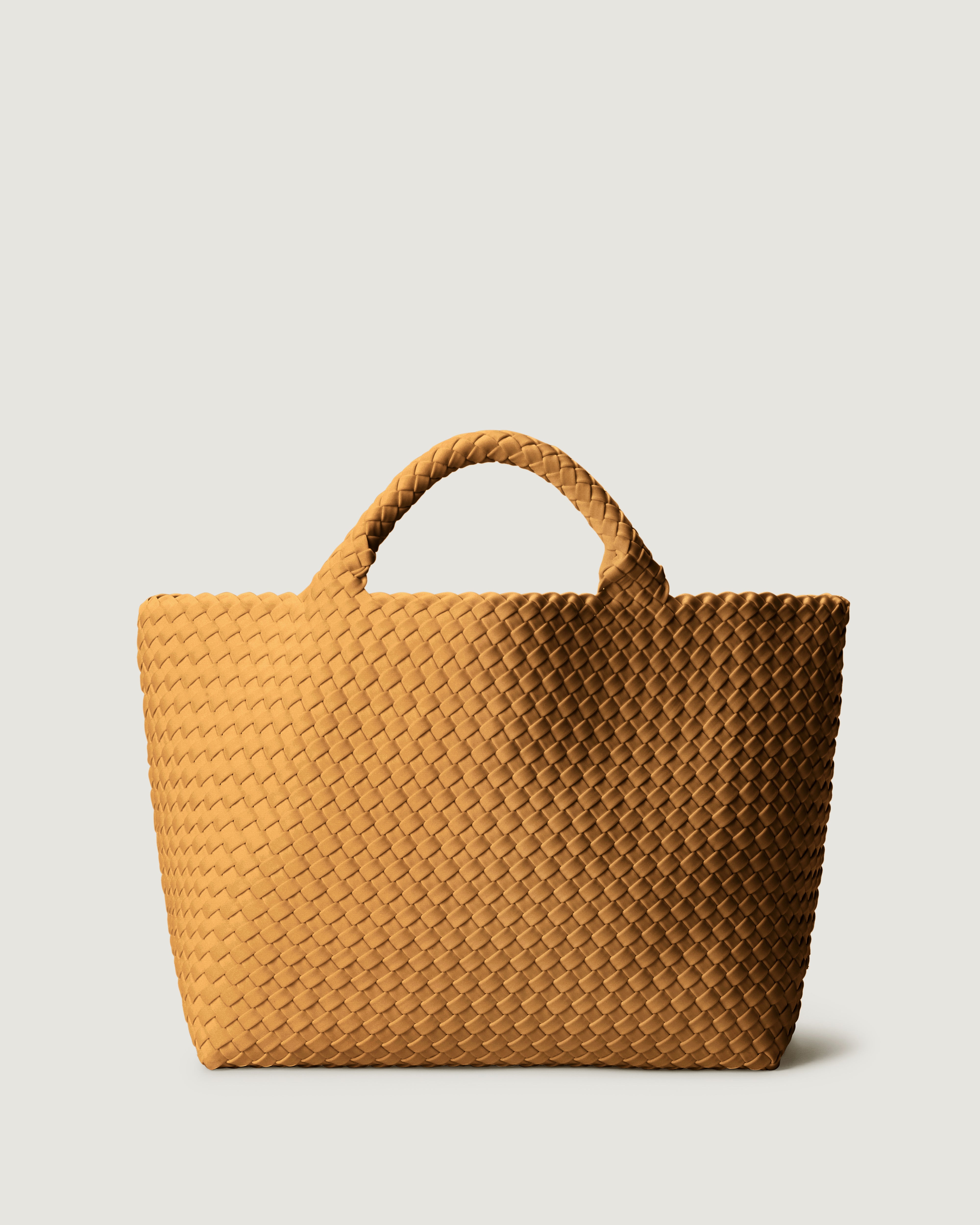 St. Barths Tote in Turmeric, handwoven in golden chartreuse neoprene. Featuring an open top, and woven top handles.