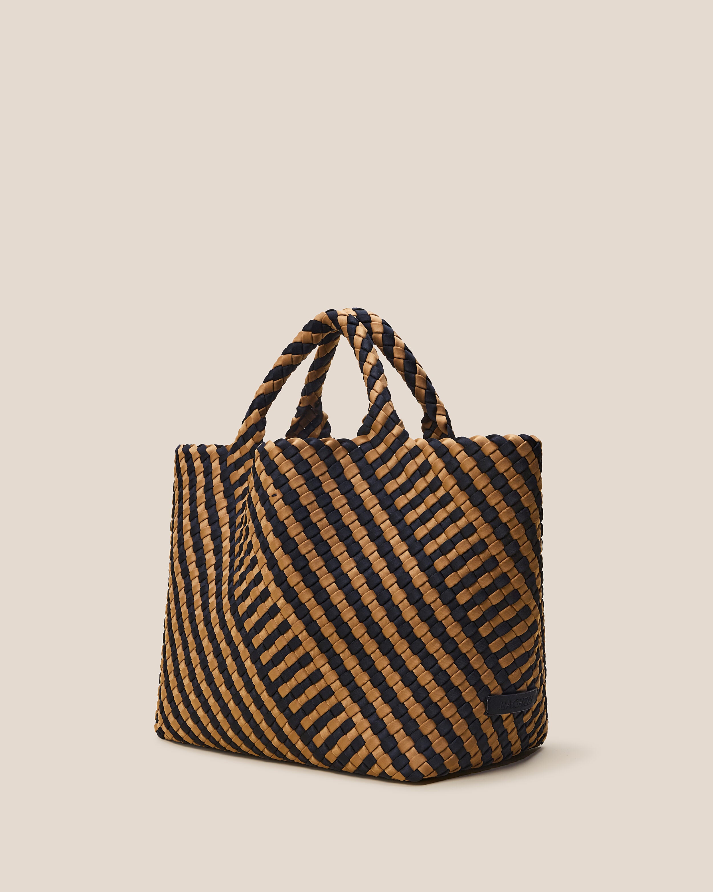 St. Barths Tote in Ravenna shown from a side angle, highlighting its handwoven neoprene construction and open top.
