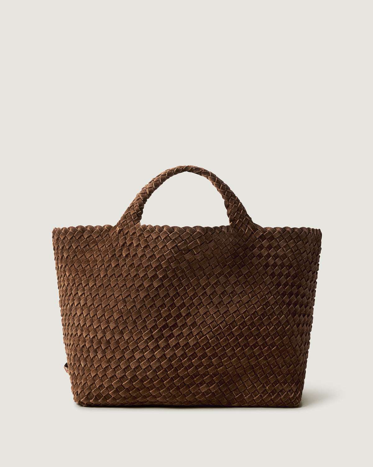 St. Barths Tote in Teak, a saddle brown tone, in handwoven suede, featuring a magnetic closure, and woven top handles.