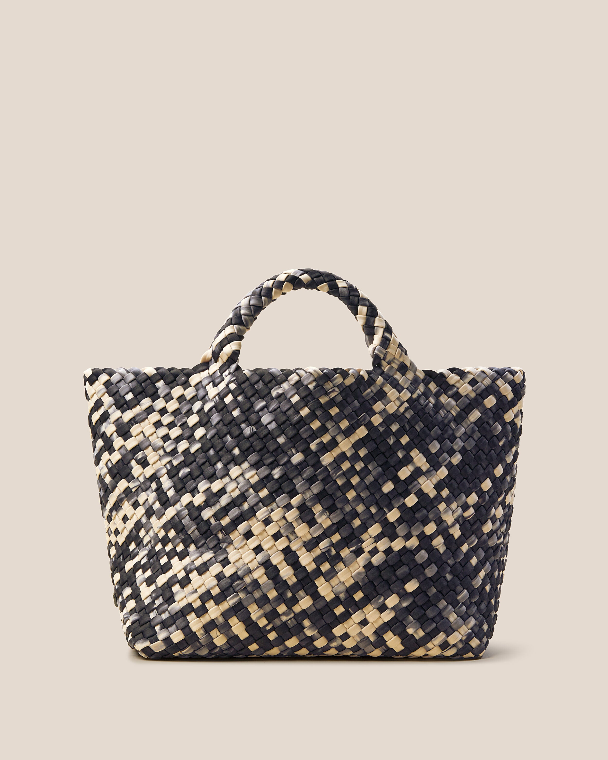 St. Barths Tote in Nimbus, a cream and black tone, in handwoven neoprene, featuring an open top, and woven top handles.