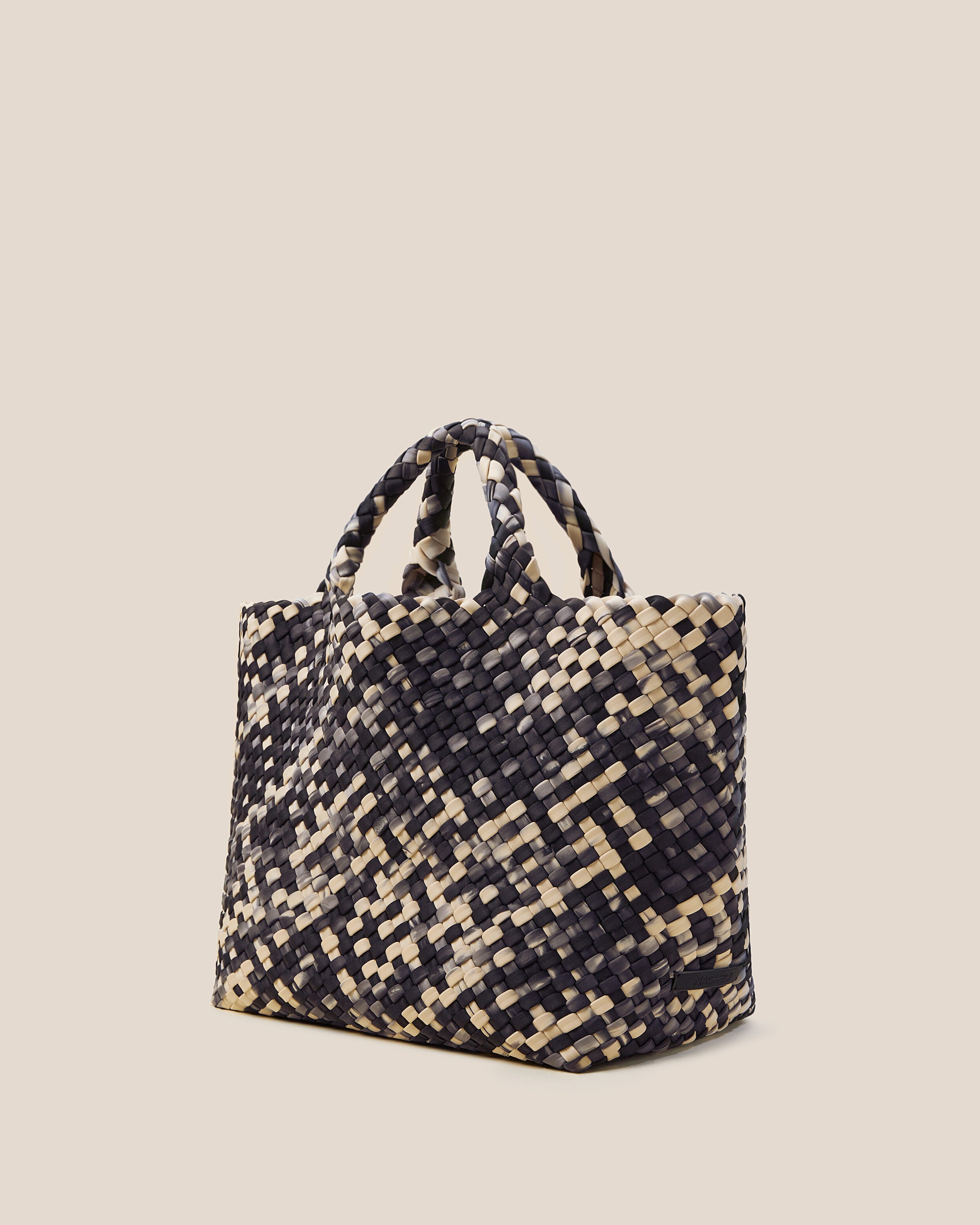 St. Barths Tote in Nimbus shown from a side angle, highlighting its handwoven neoprene construction and open top.