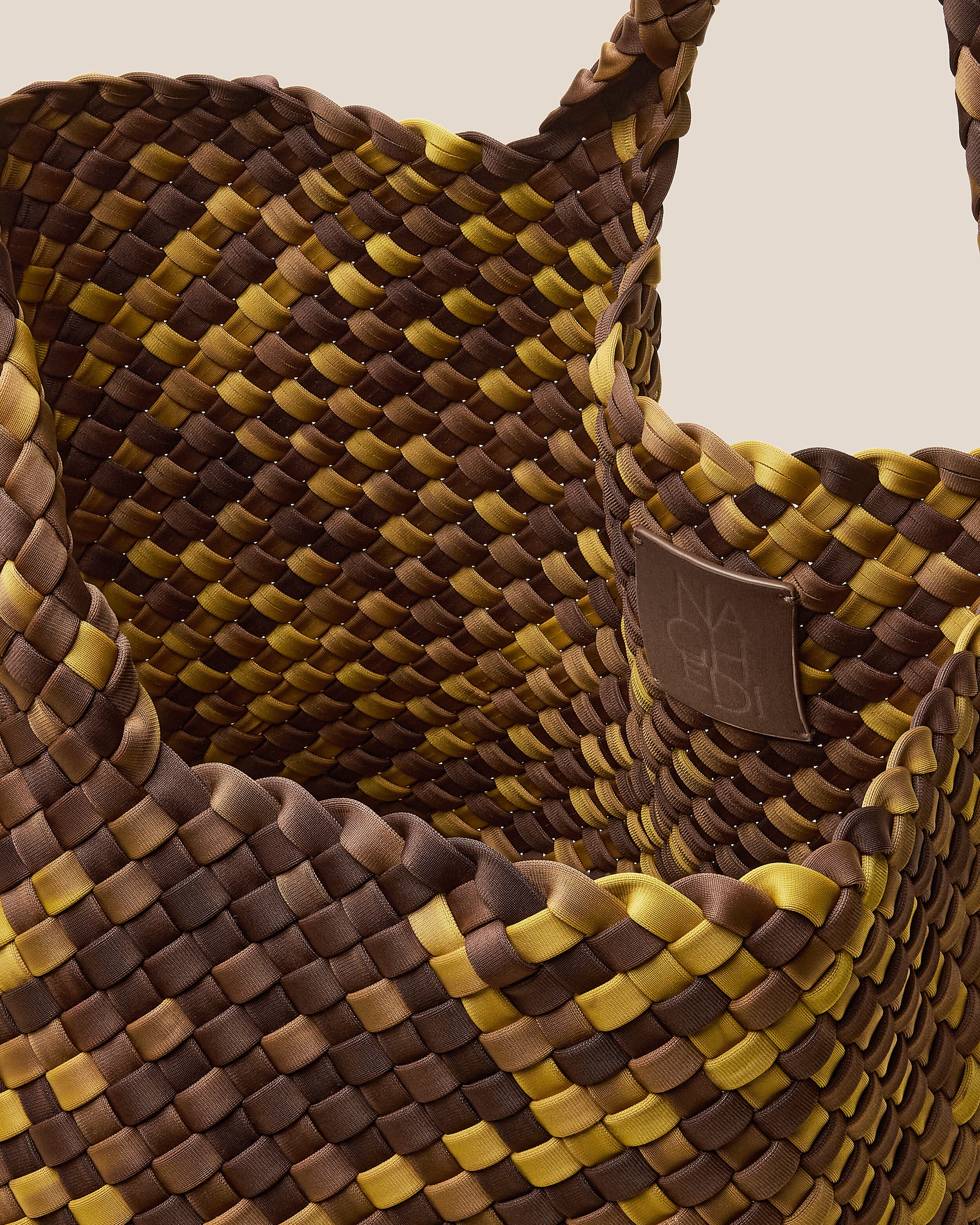 Interior close-up of St. Barths Tote in Tortoiseshell showing its open top, and unlined interior.