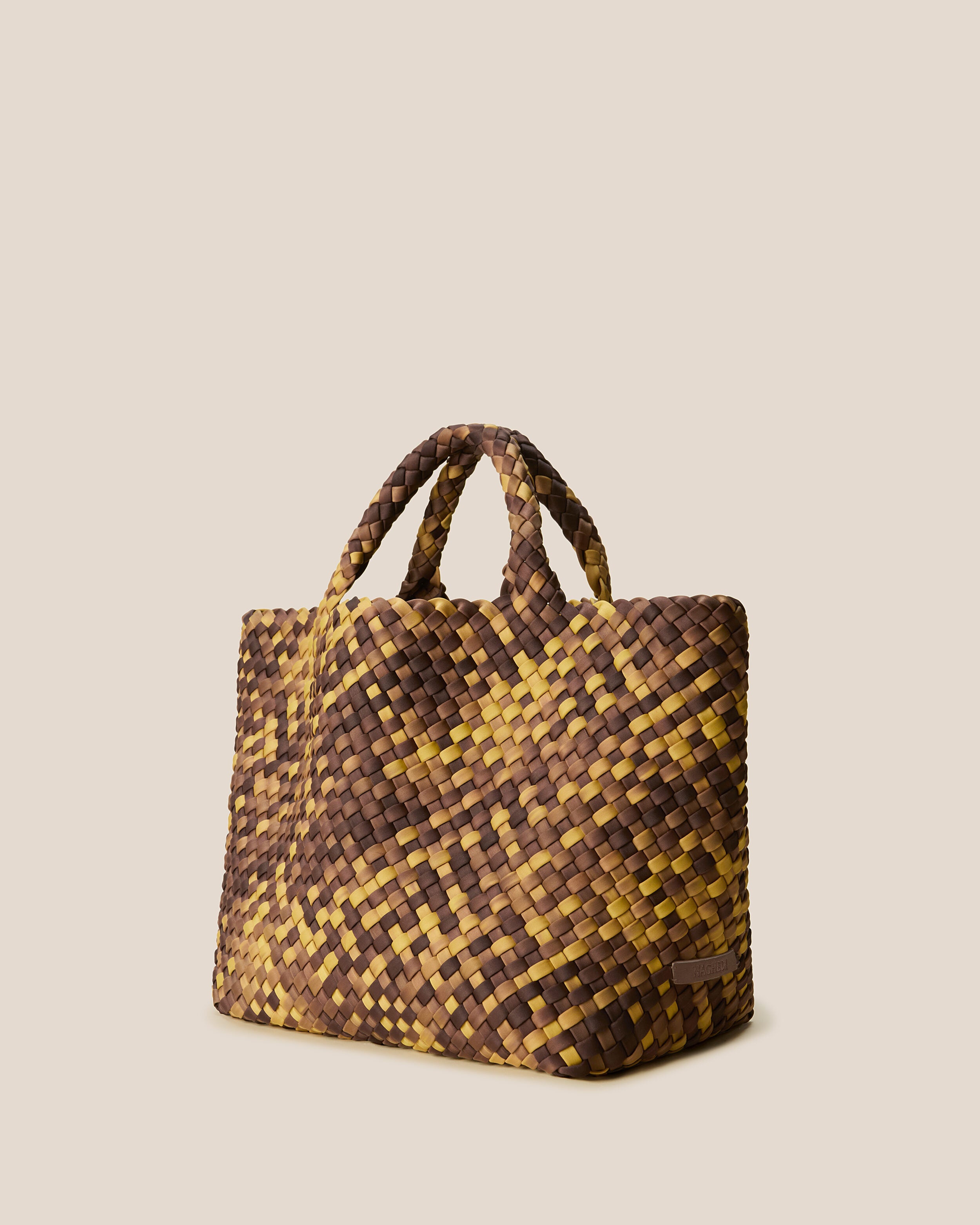 St. Barths Tote in Tortoiseshell shown from a side angle, highlighting its handwoven neoprene construction and open top.