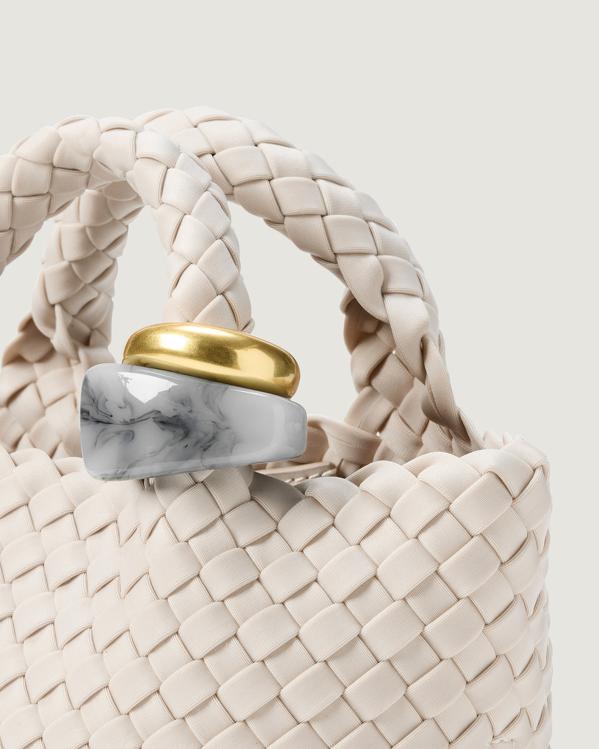 Close up of the St Barths Tote in Linen highlighting the two beads on the handle.