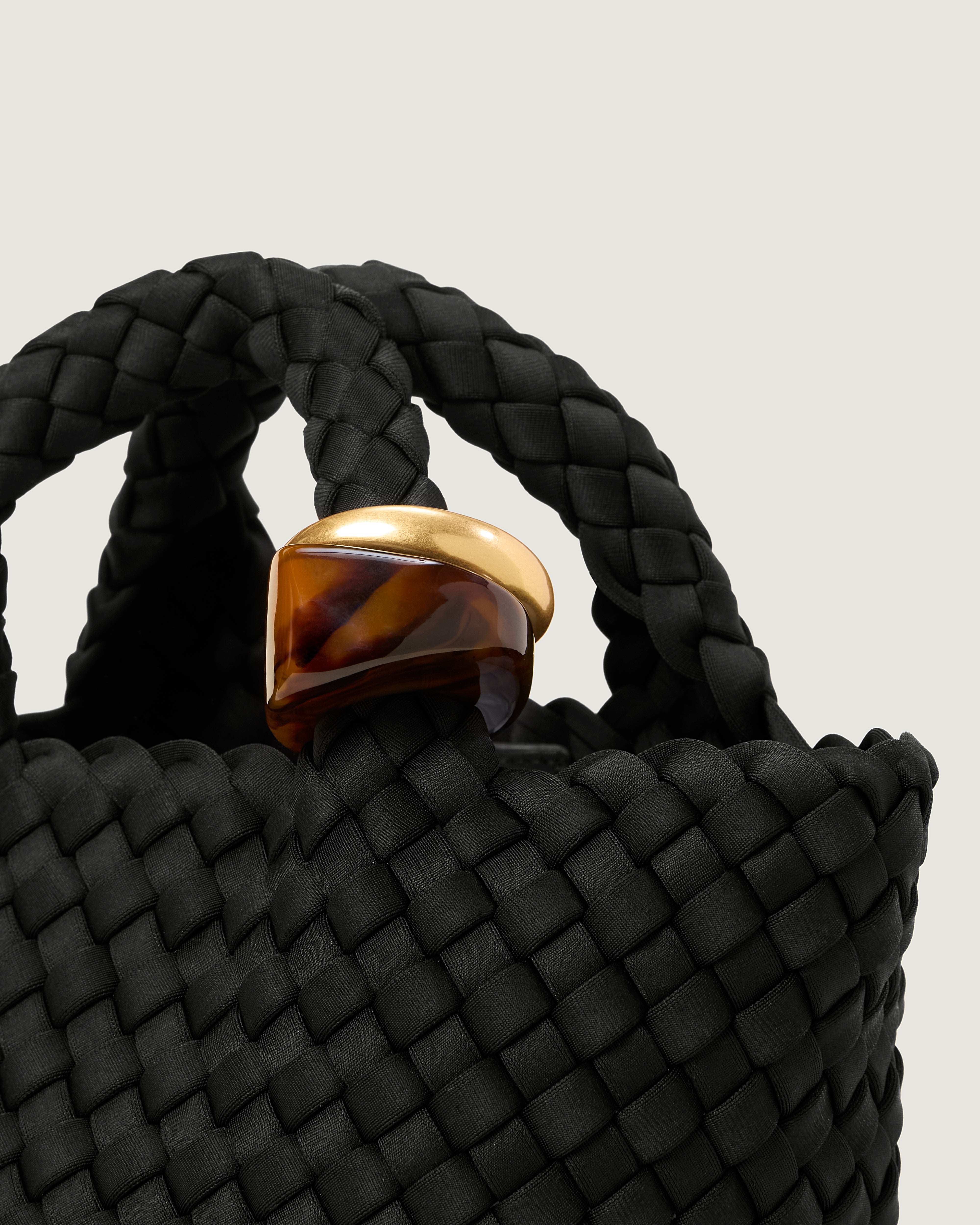 Close up of the St Barths Tote in Onyx highlighting the 2 beads on the handle.