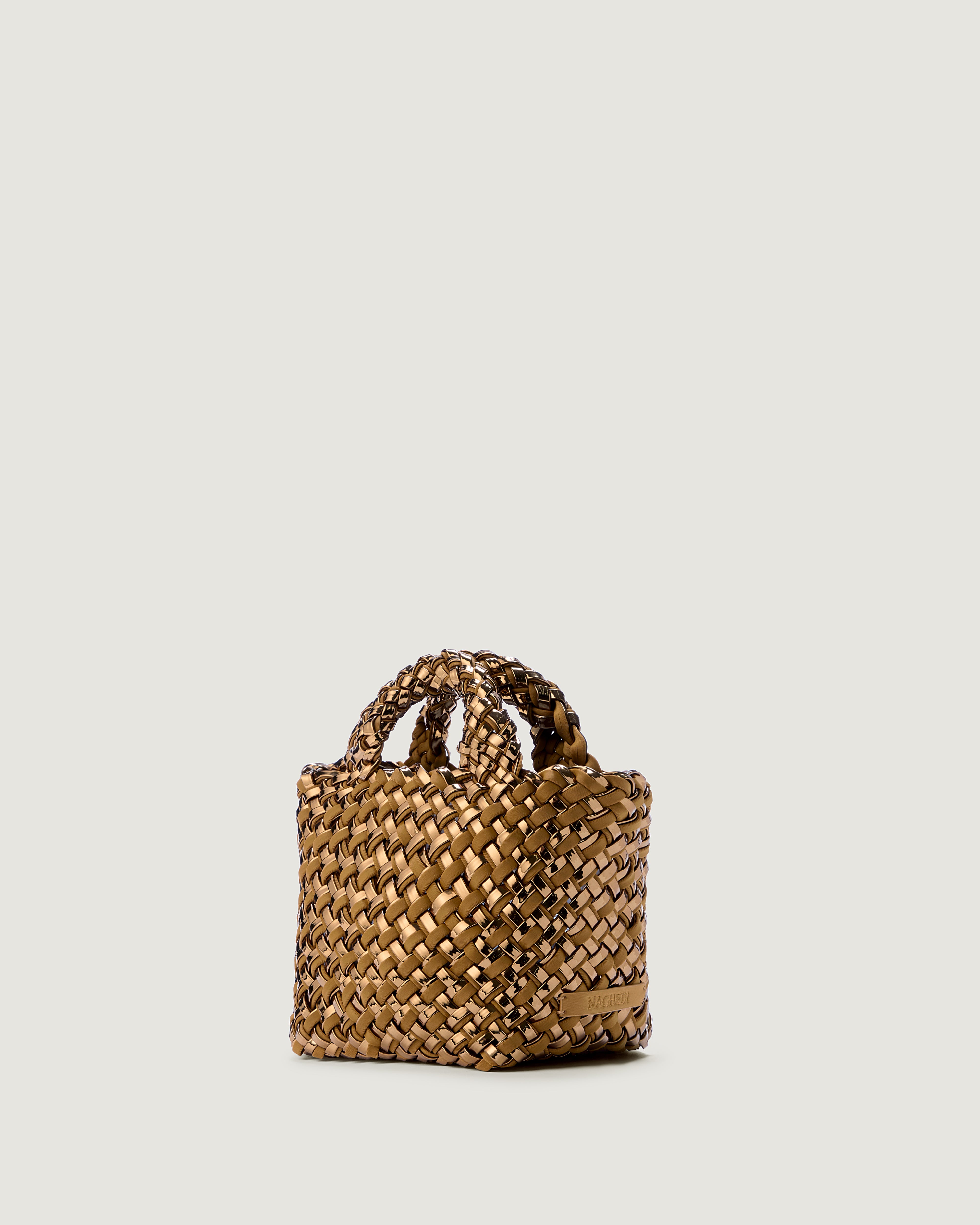 St. Barths Tote in Firenze shown from a side angle, highlighting its handwoven metallic-coated nylon construction and open top.