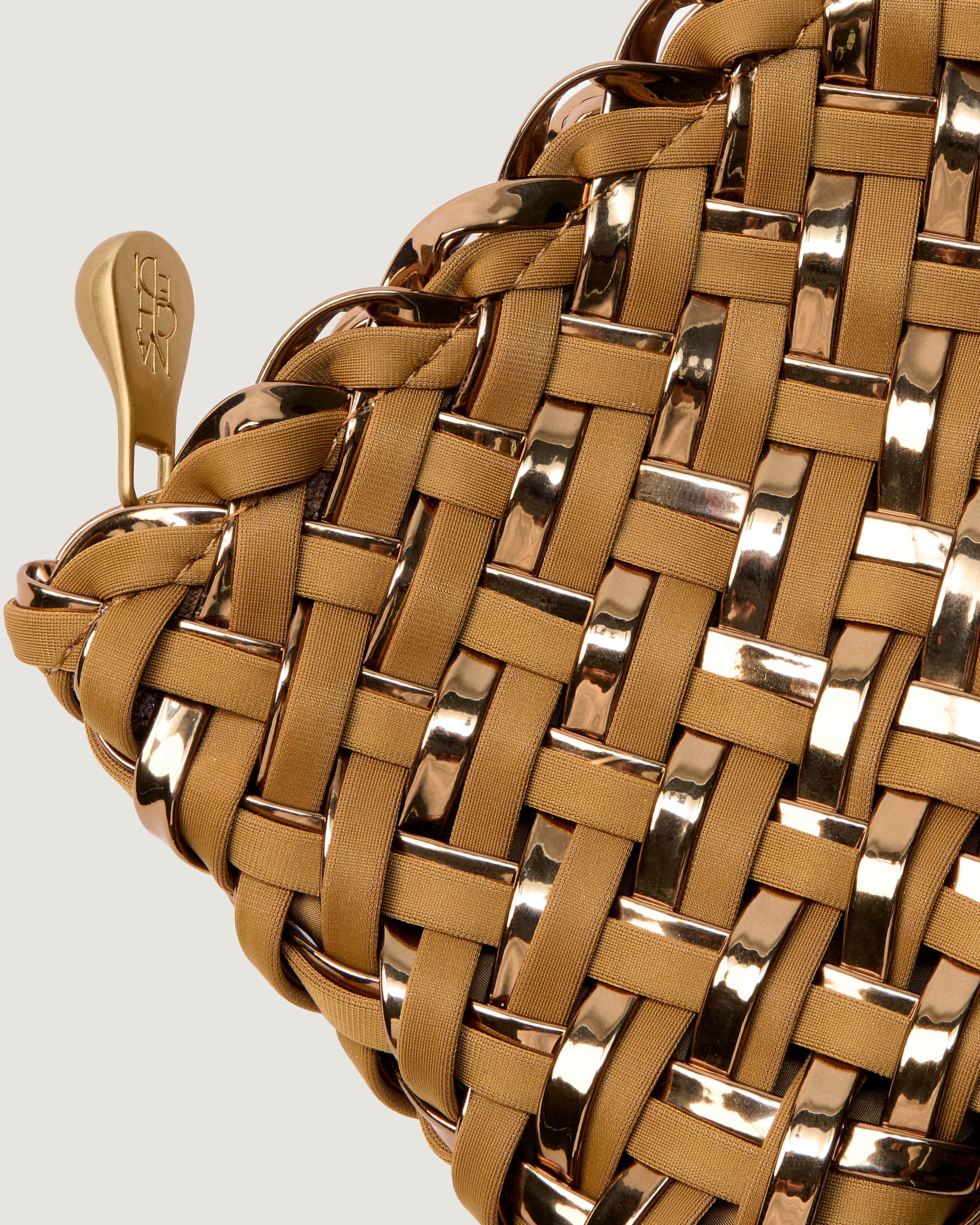 Close-up of included matching metallic-coated handwoven zippered pouch.