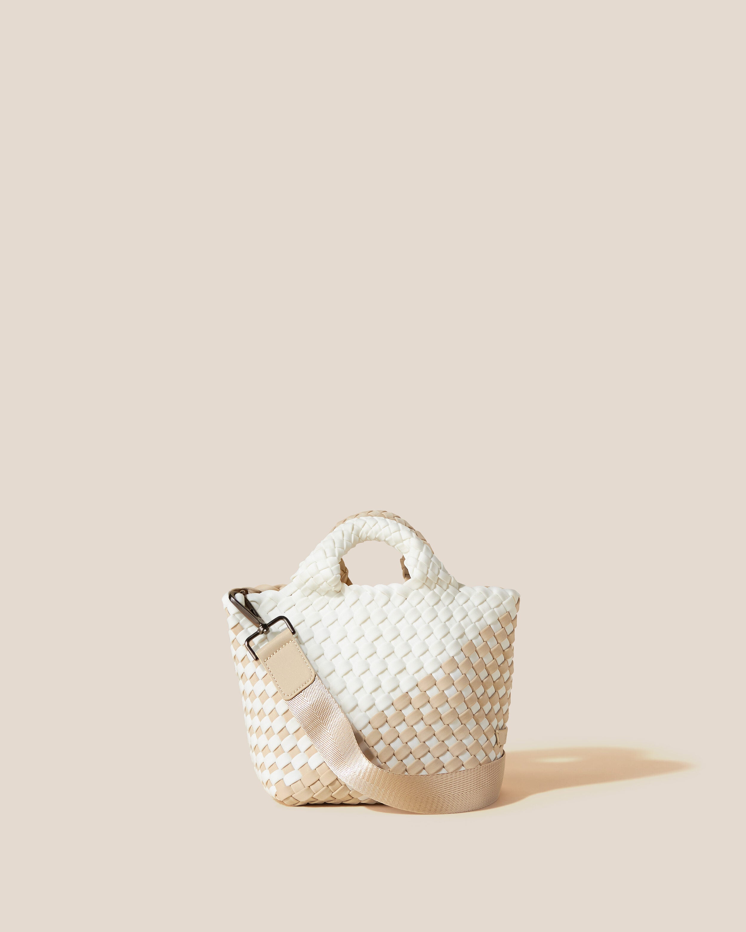 St. Barths Tote in Athena, a white and cream tone, in handwoven neoprene, featuring an open top, woven top handles, and detachable, adjustable nylon crossbody strap.