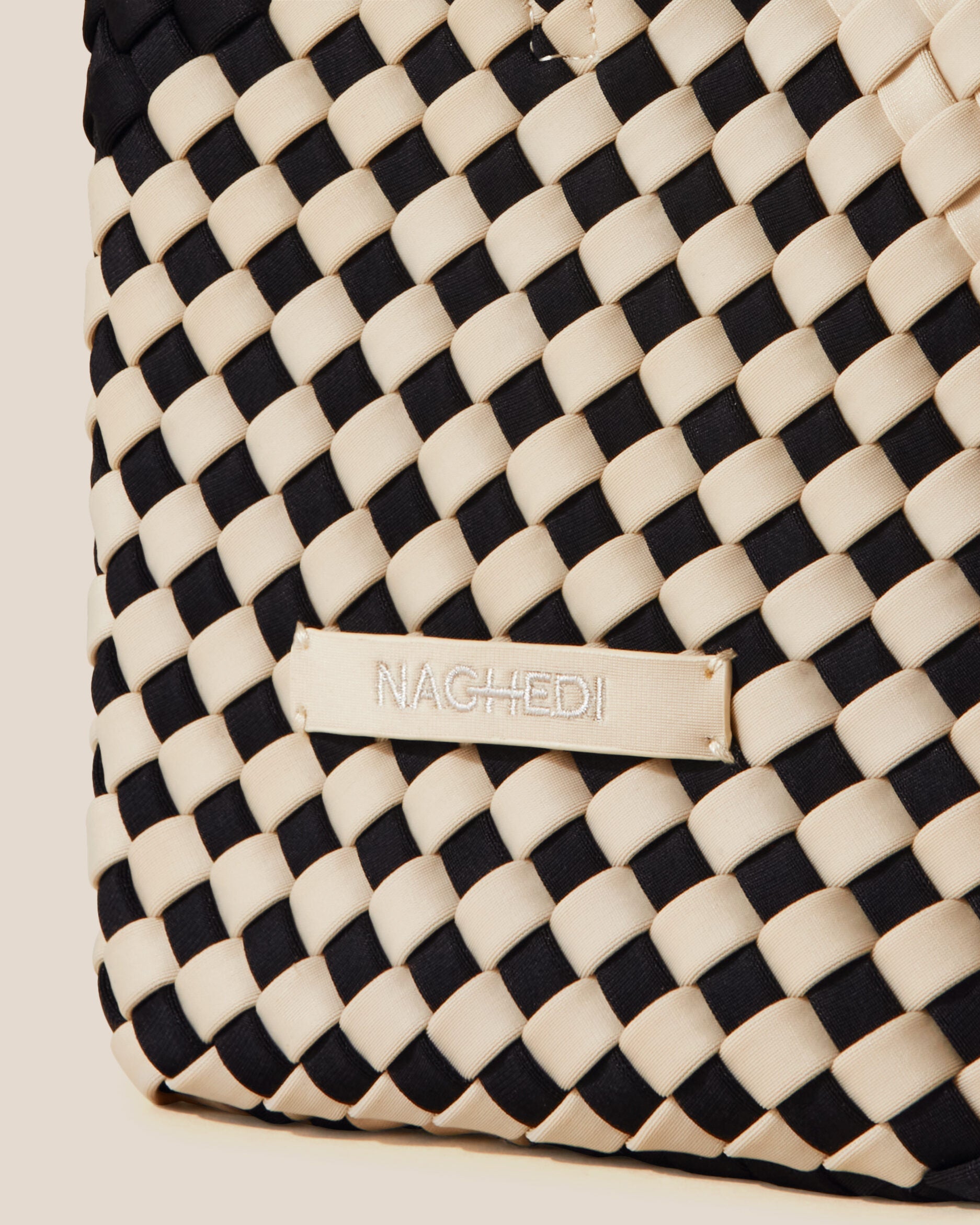 Close-up of stamped NAGHEDI logo on St. Barths Tote in Indio.
