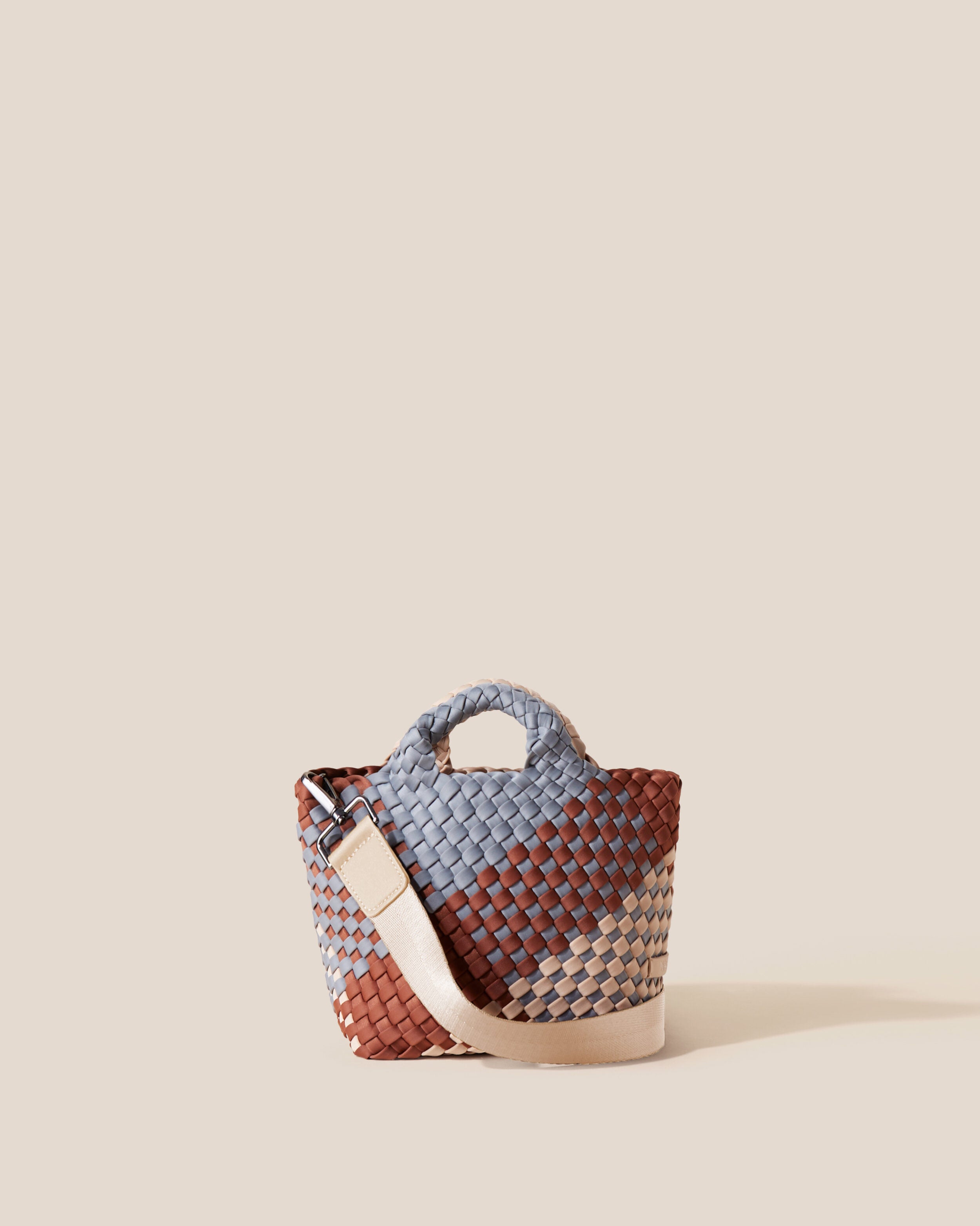 St. Barths Tote in Taos, a clay brown, nude and gray tone, in handwoven neoprene, featuring an open top, woven top handles, and detachable, adjustable nylon crossbody strap.