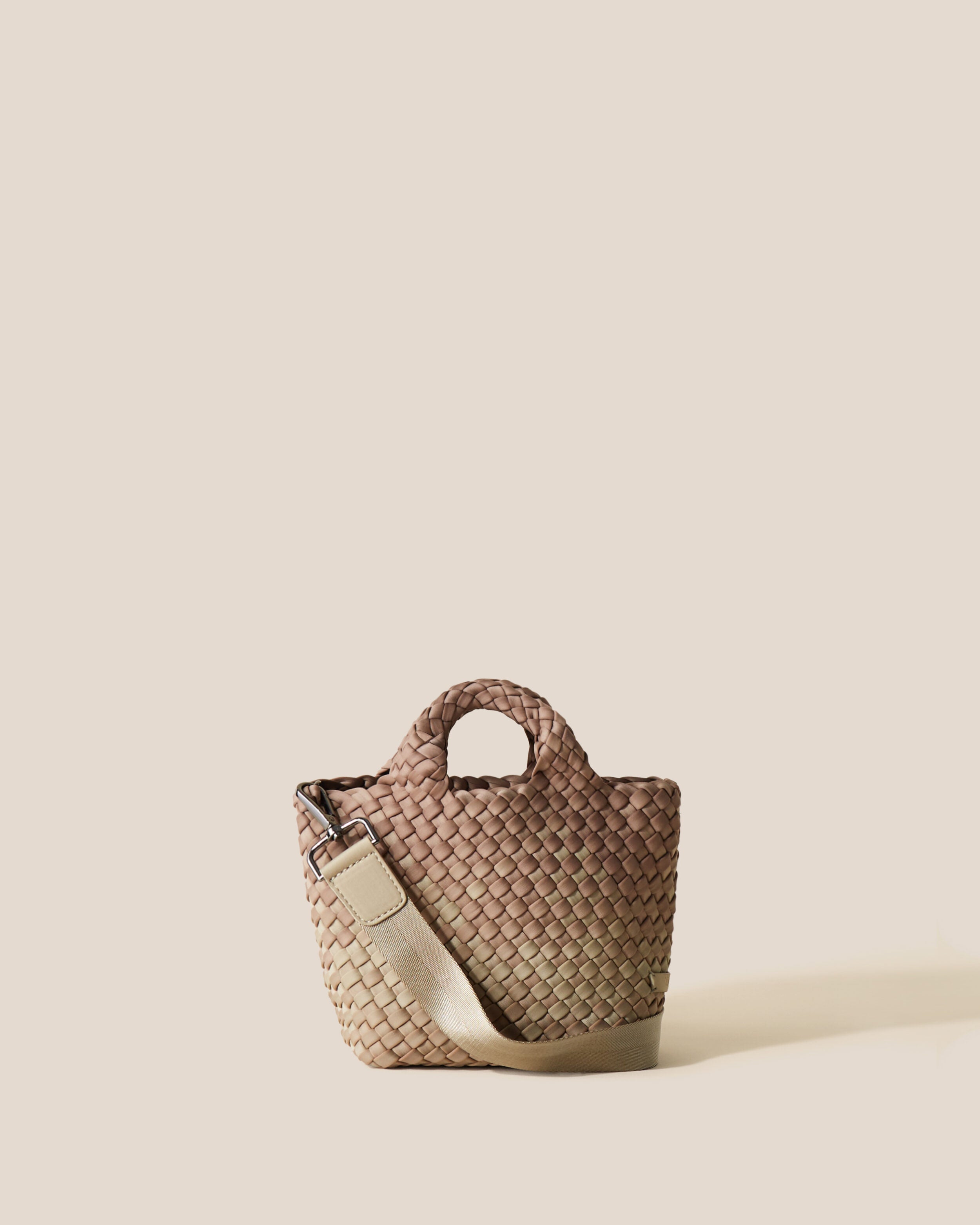 St. Barths Tote in Bronzed, a shades of beige tone, in handwoven neoprene, featuring an open top, woven top handles, and detachable, adjustable nylon crossbody strap.