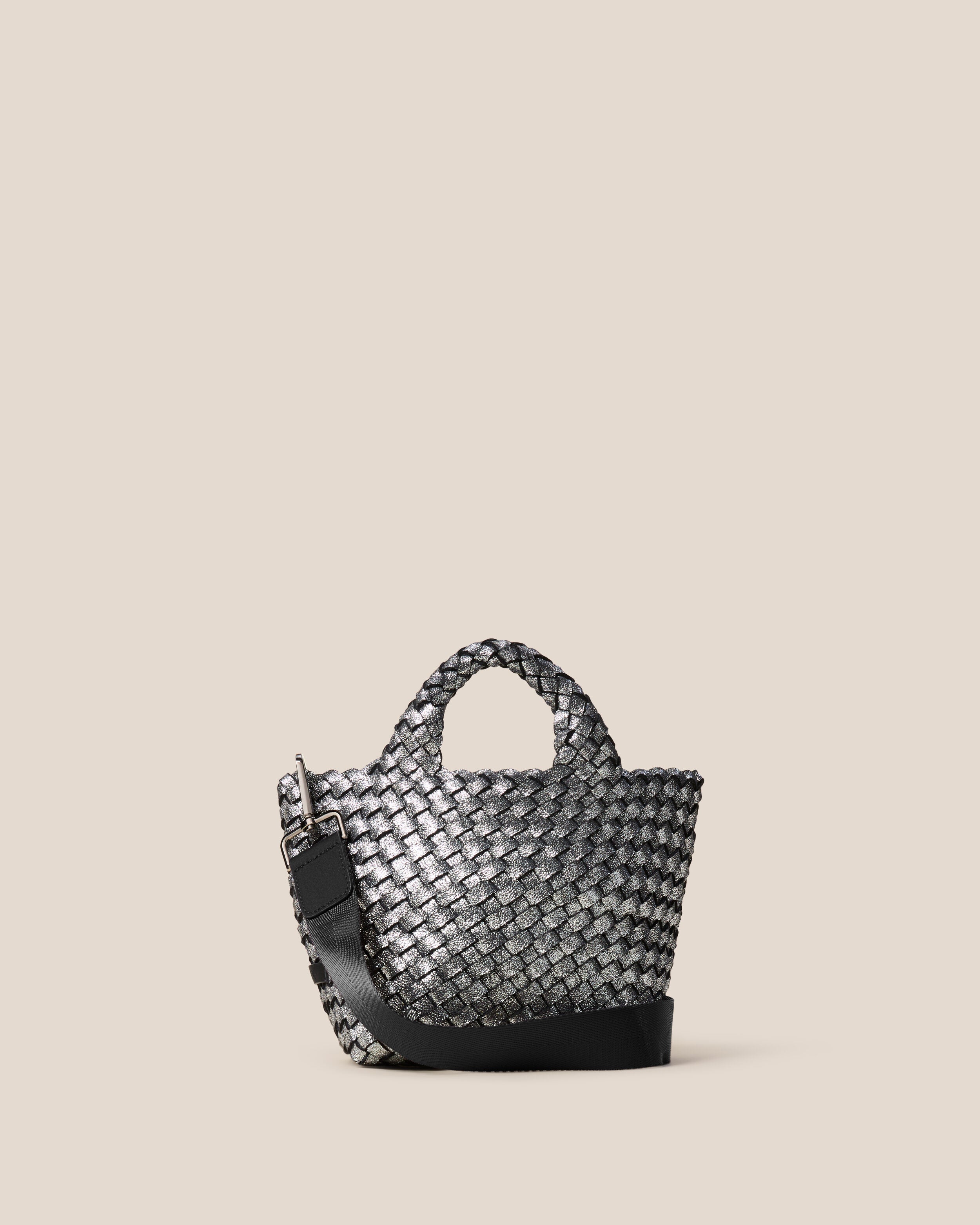 St. Barths Tote in Titanium, a silver tone, in handwoven neoprene, featuring an open top, woven top handles, and detachable, adjustable nylon crossbody strap.