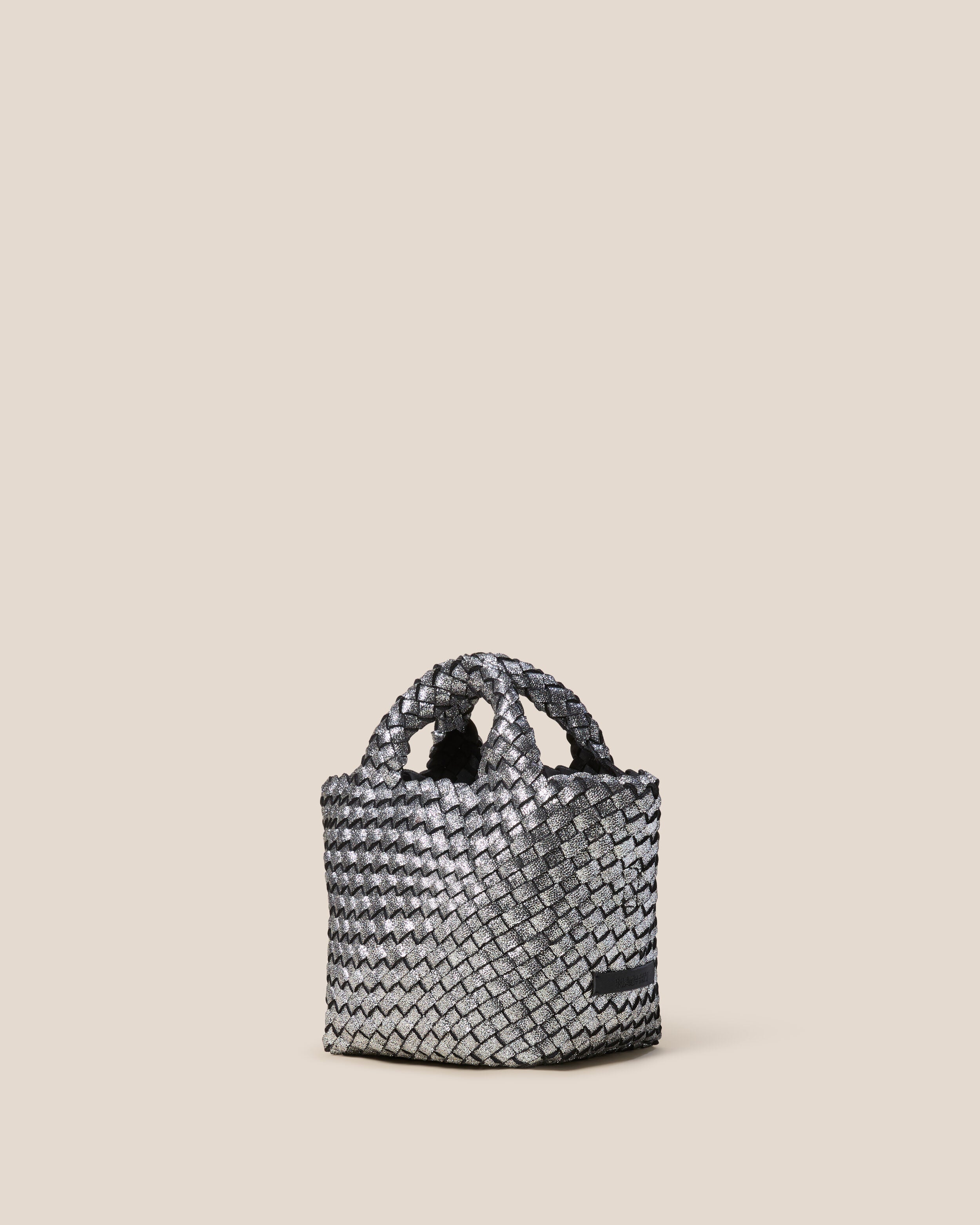 St. Barths Tote in Titanium shown from a side angle, highlighting its handwoven neoprene construction and open top.