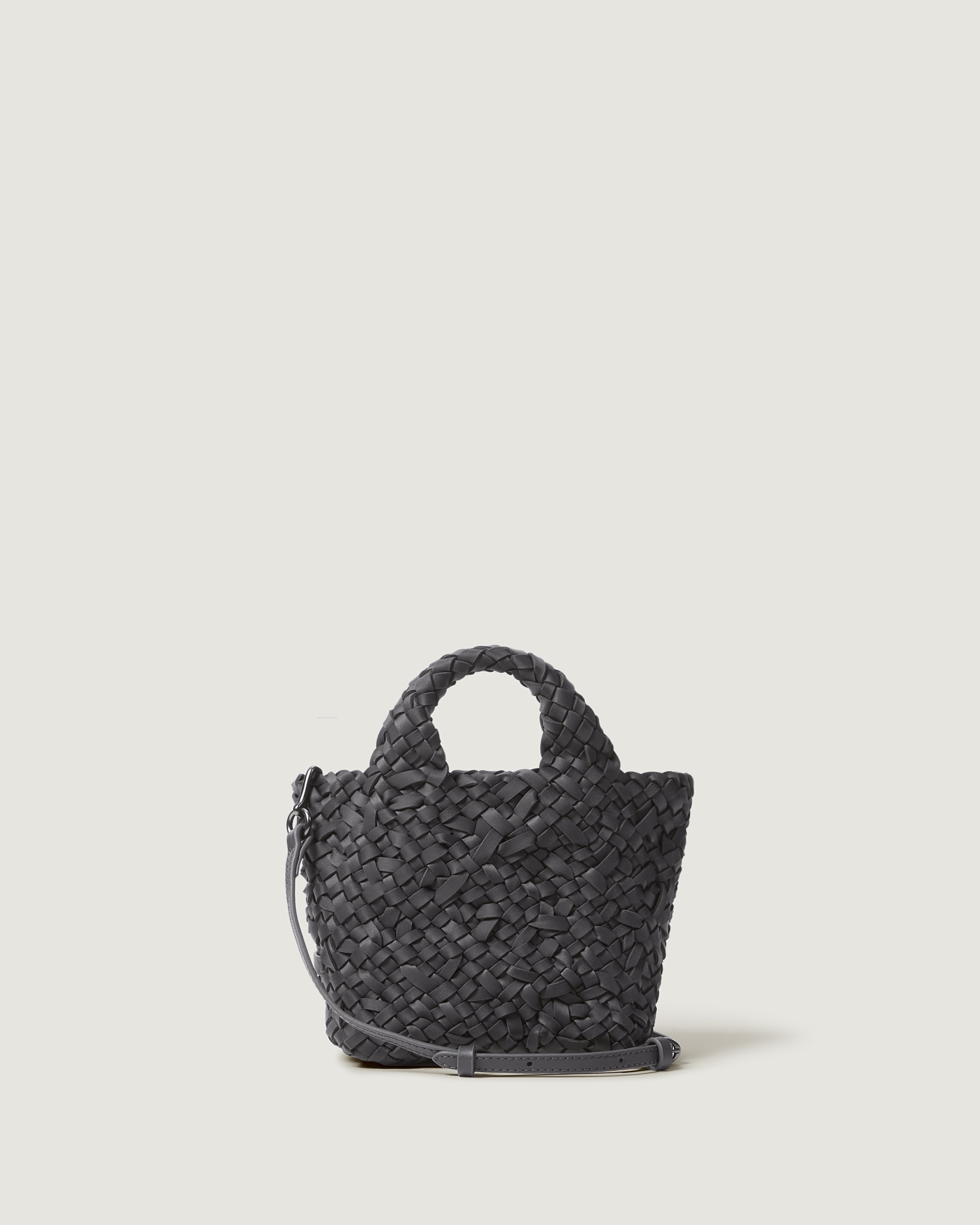 An ash gray woven basket-style neoprene handbag with a top handle and a leather shoulder strap.
