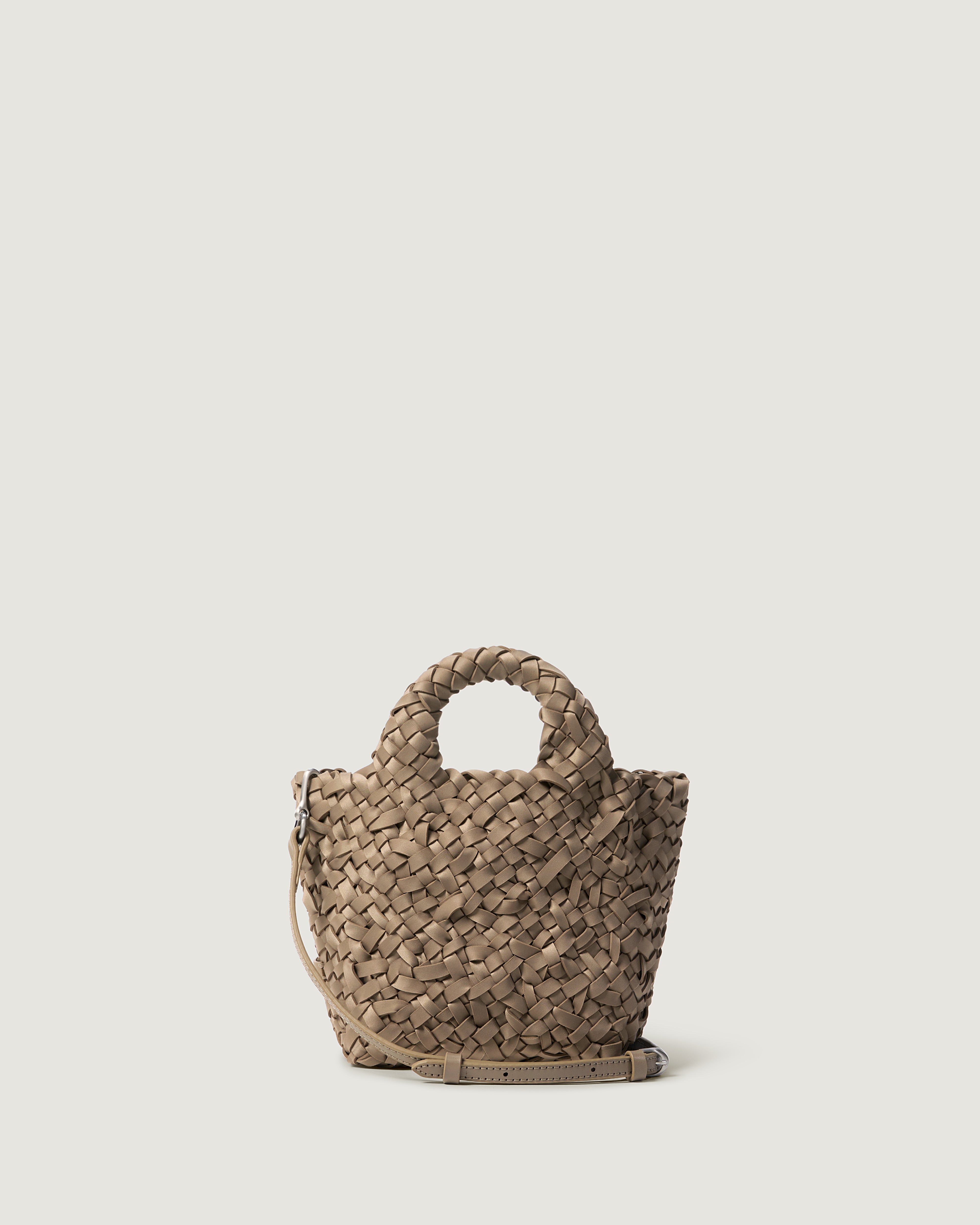A cool taupe woven basket-style neoprene handbag with a top handle and a leather shoulder strap.
